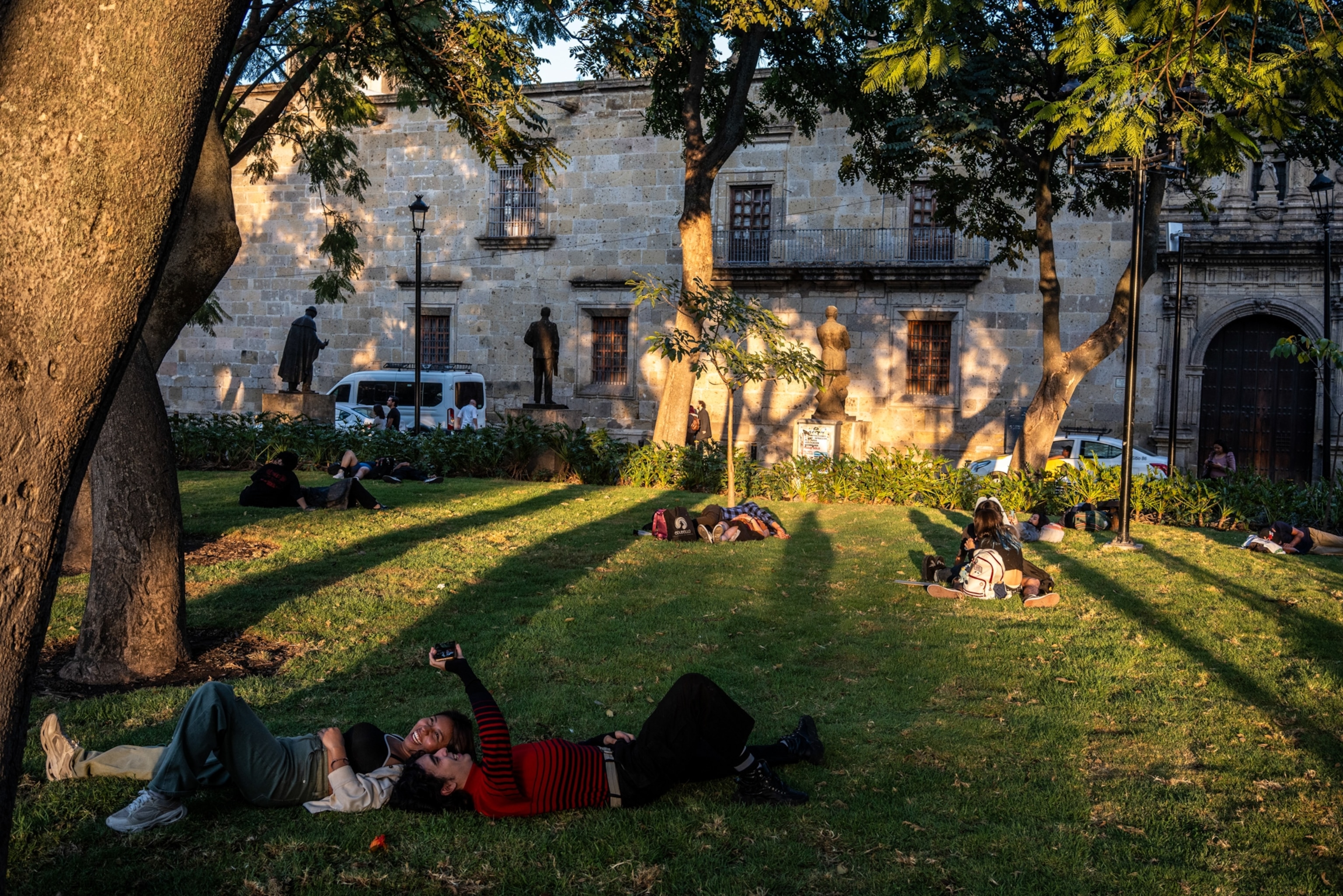 People lying on the grass of the Ronda de los Jaliciences Ilustres.