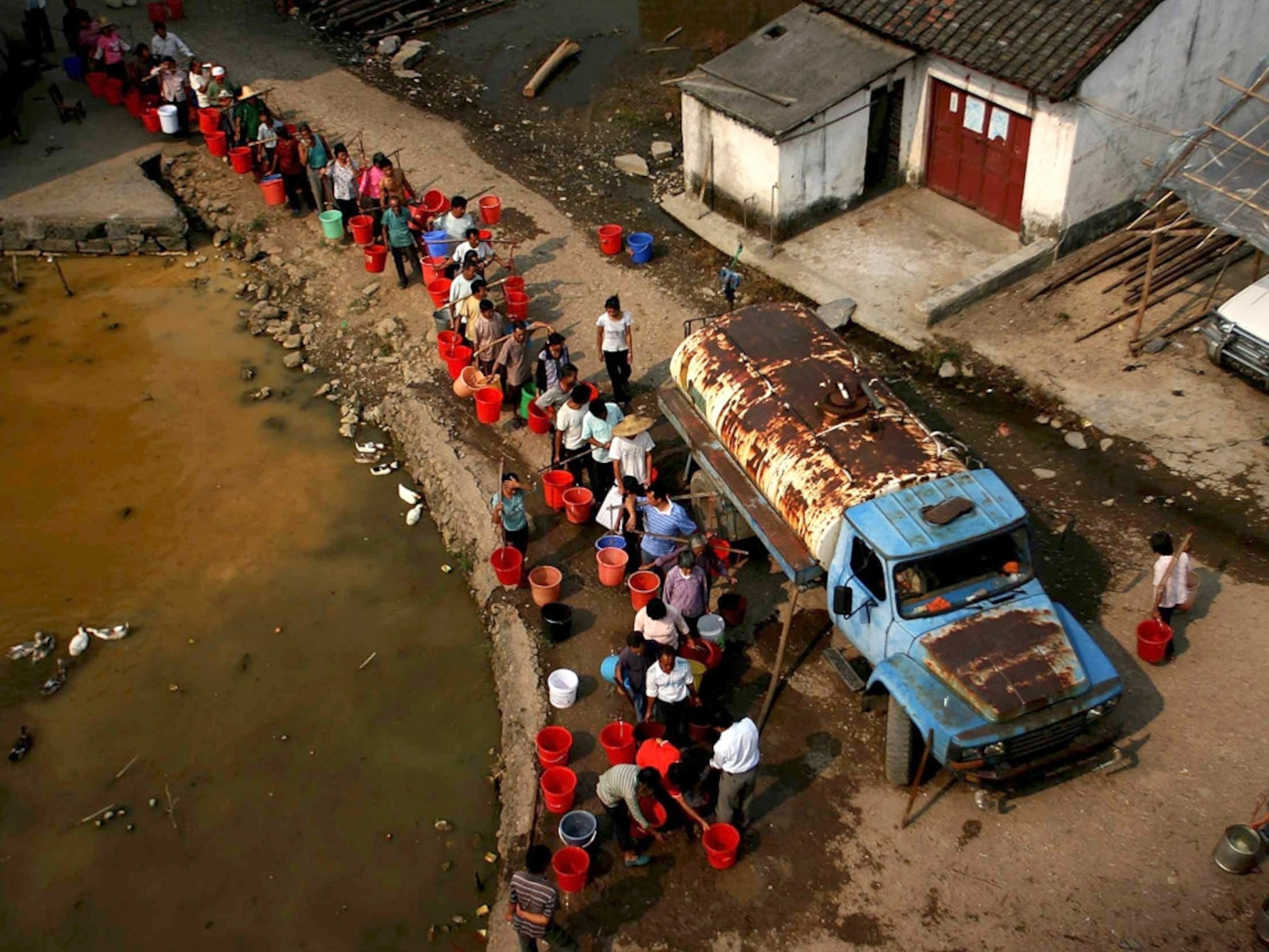 Villagers waiting for a water truck