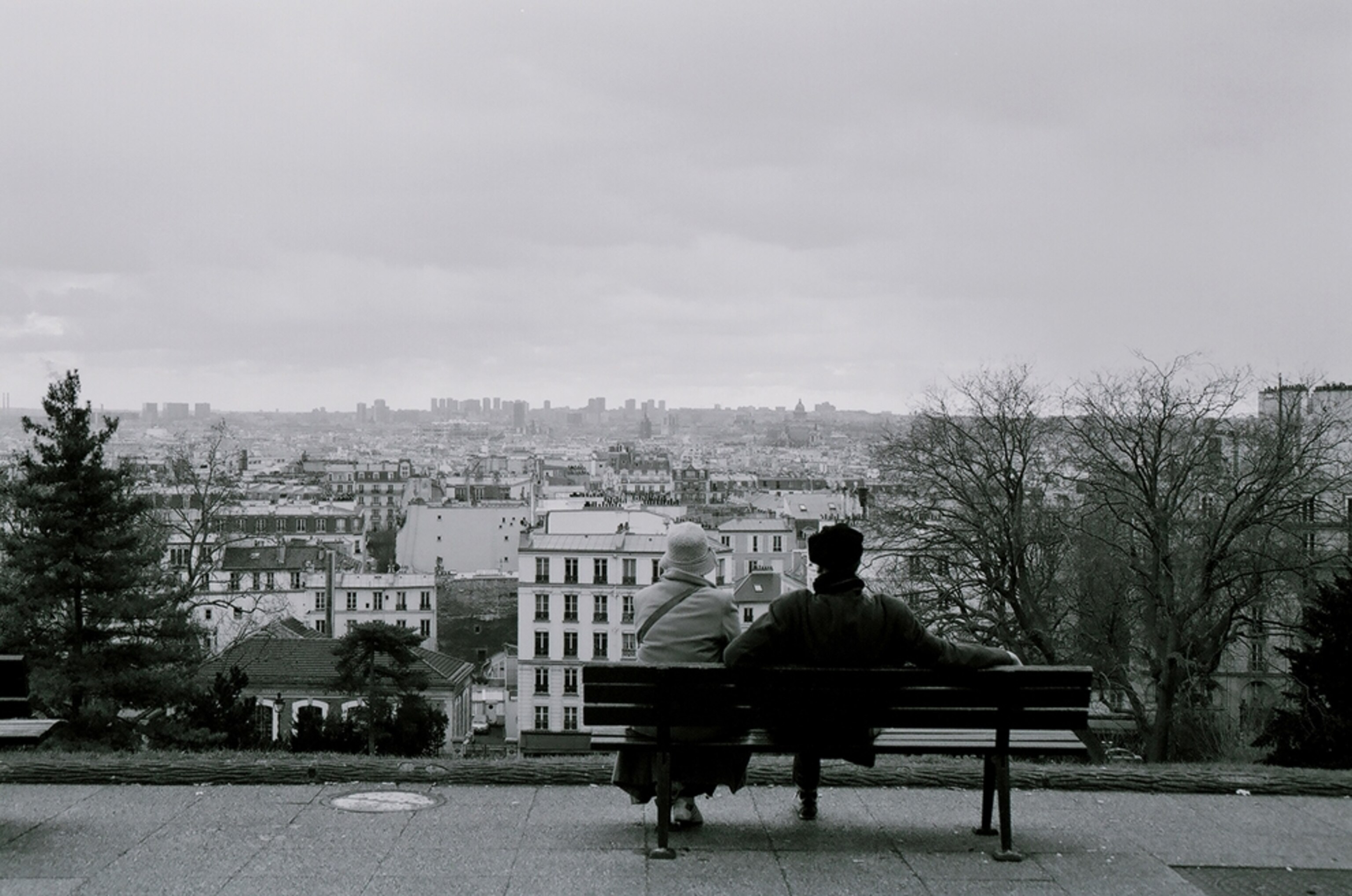 Couple sitting on a bench in Montmartre, Paris, France