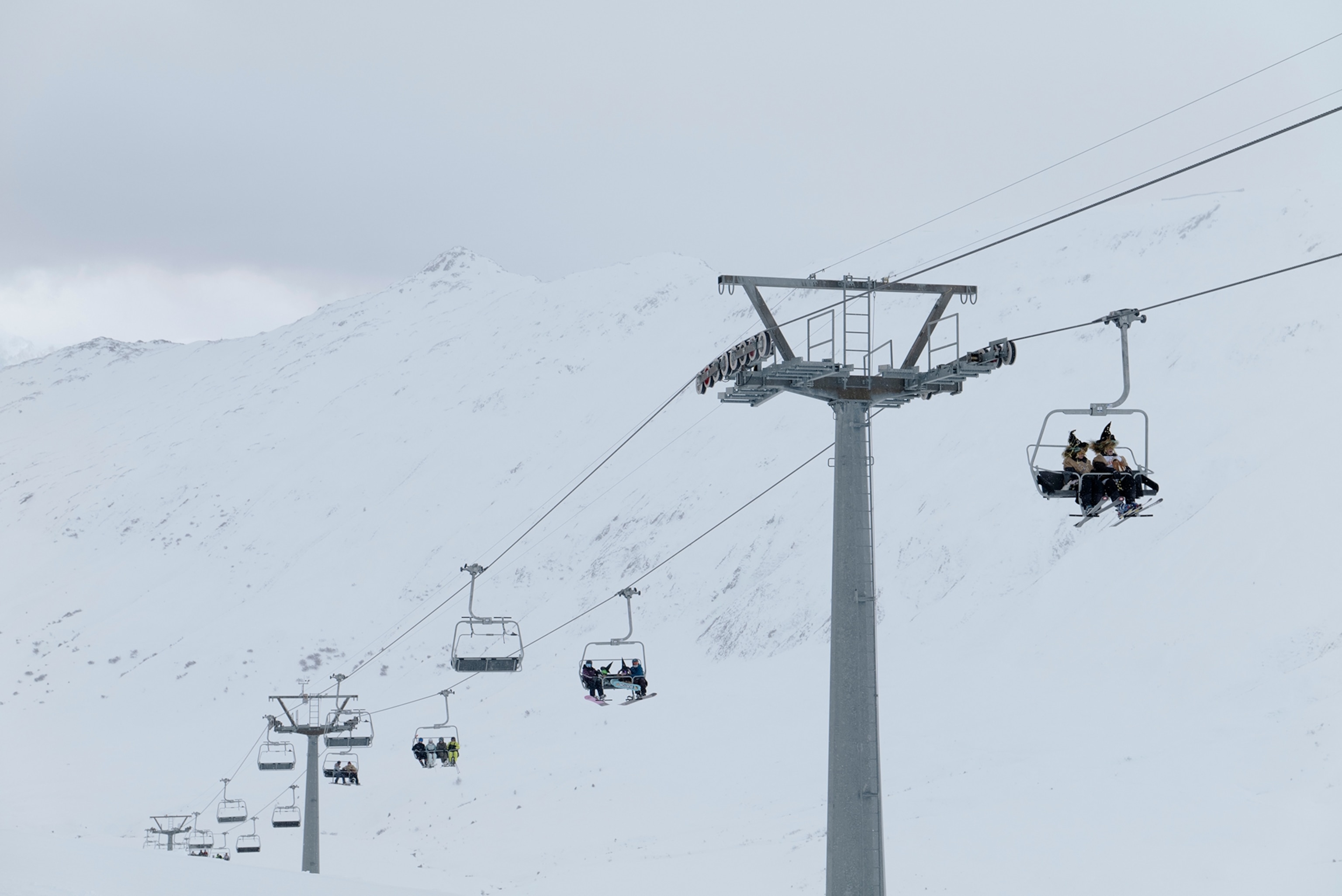 Skiers dressed as witches ride the Kelchbach ski lift during the Belalp Hexen festival in Belalp, Switzerland. The festival includes races and witch themed activities.