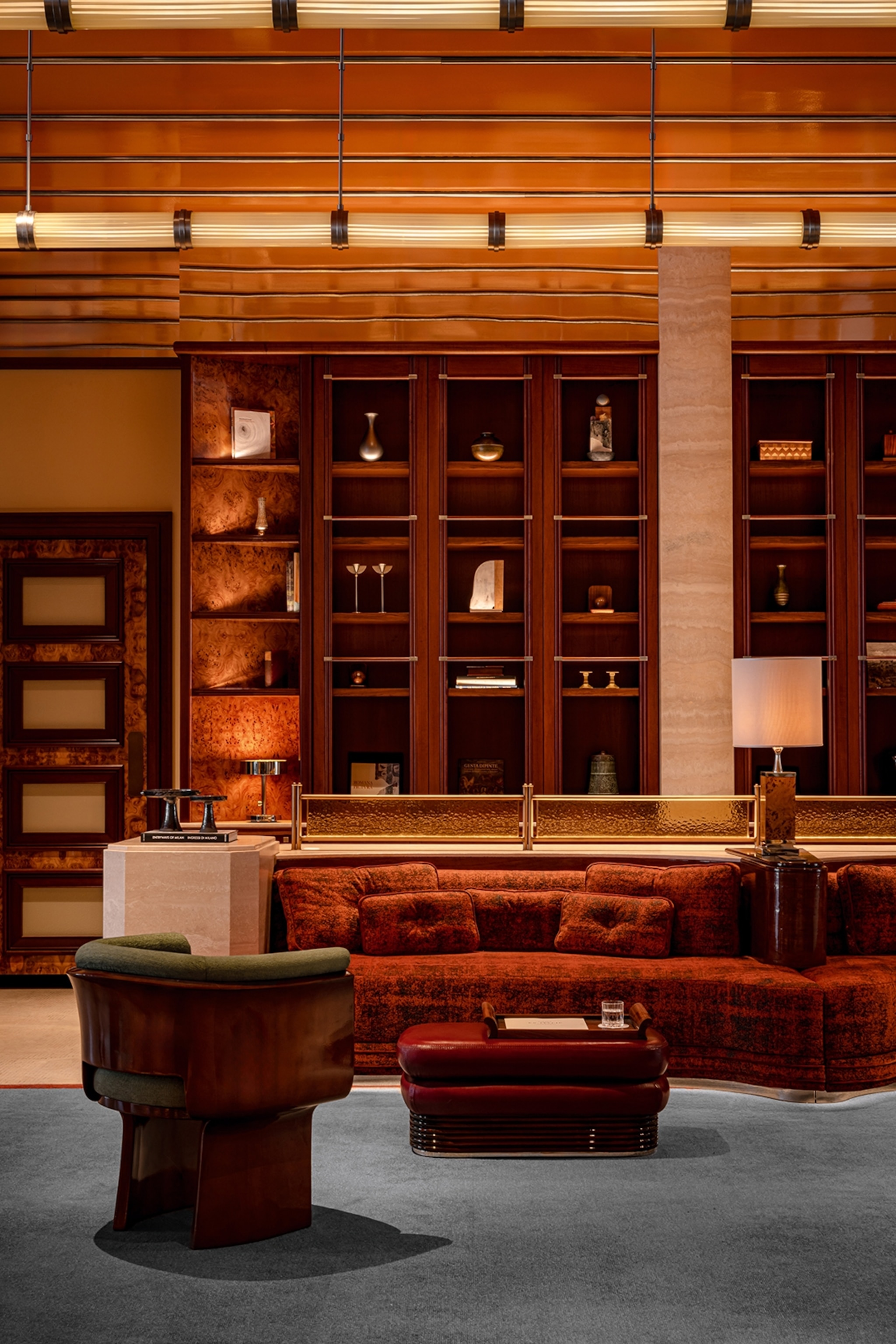 A sleek and moody lounge with velvet sofas.