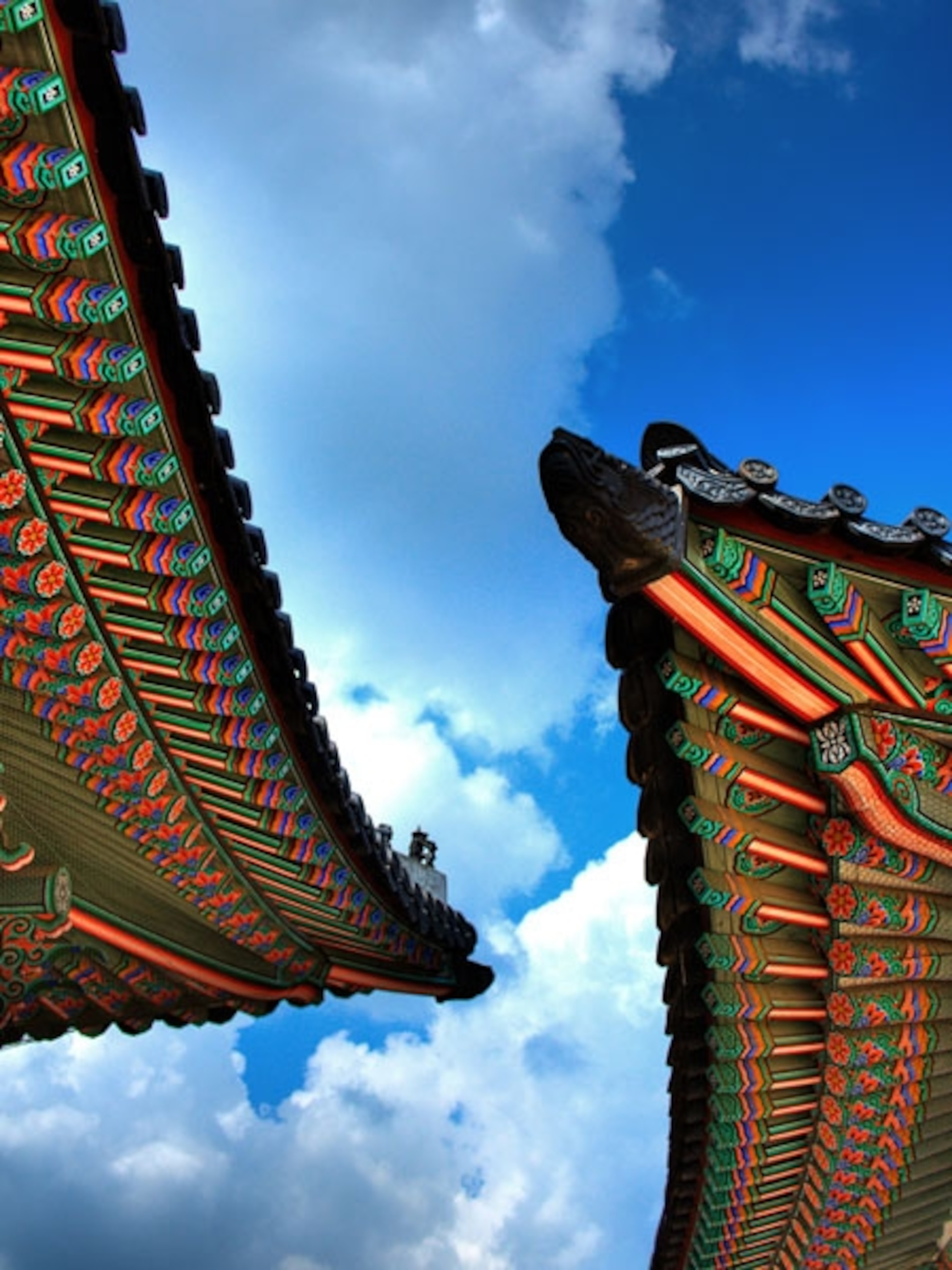 Colorful eaves of pagoda roofs beneath a blue sky