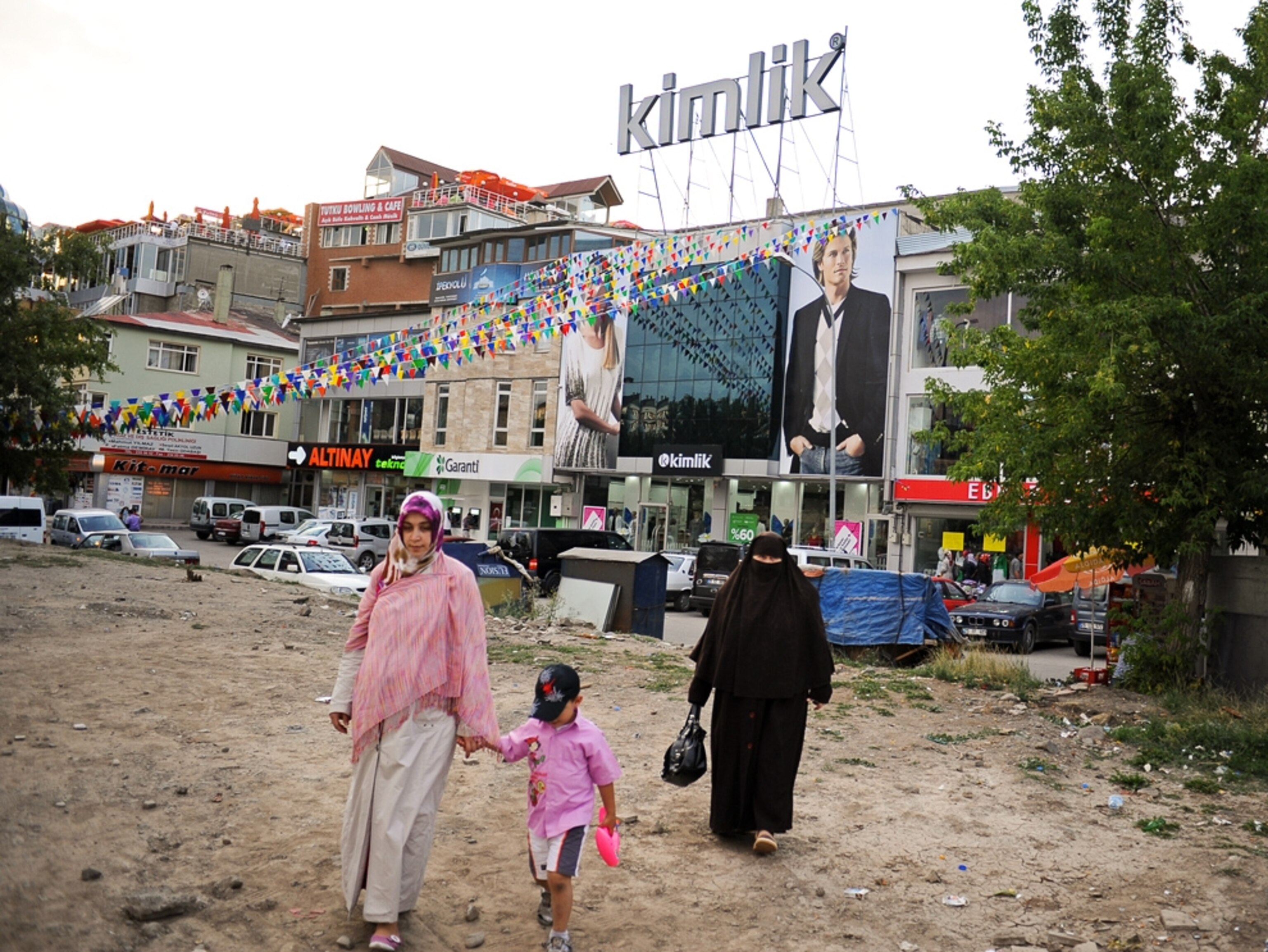 Muslim women walk away from a city street in Erzurum, Turkey