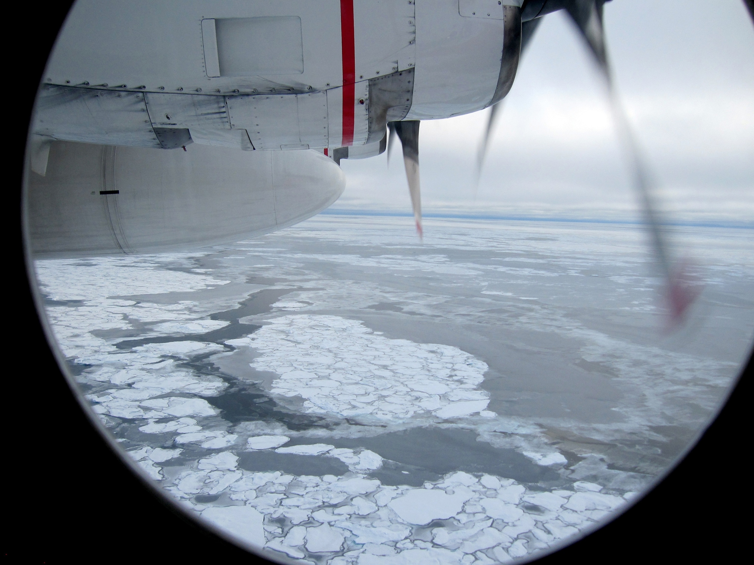 Broken Arctic sea ice as seen from a window in from a U.S. Coast Guard C130 flight over the Arctic Ocean September 30, 2009.