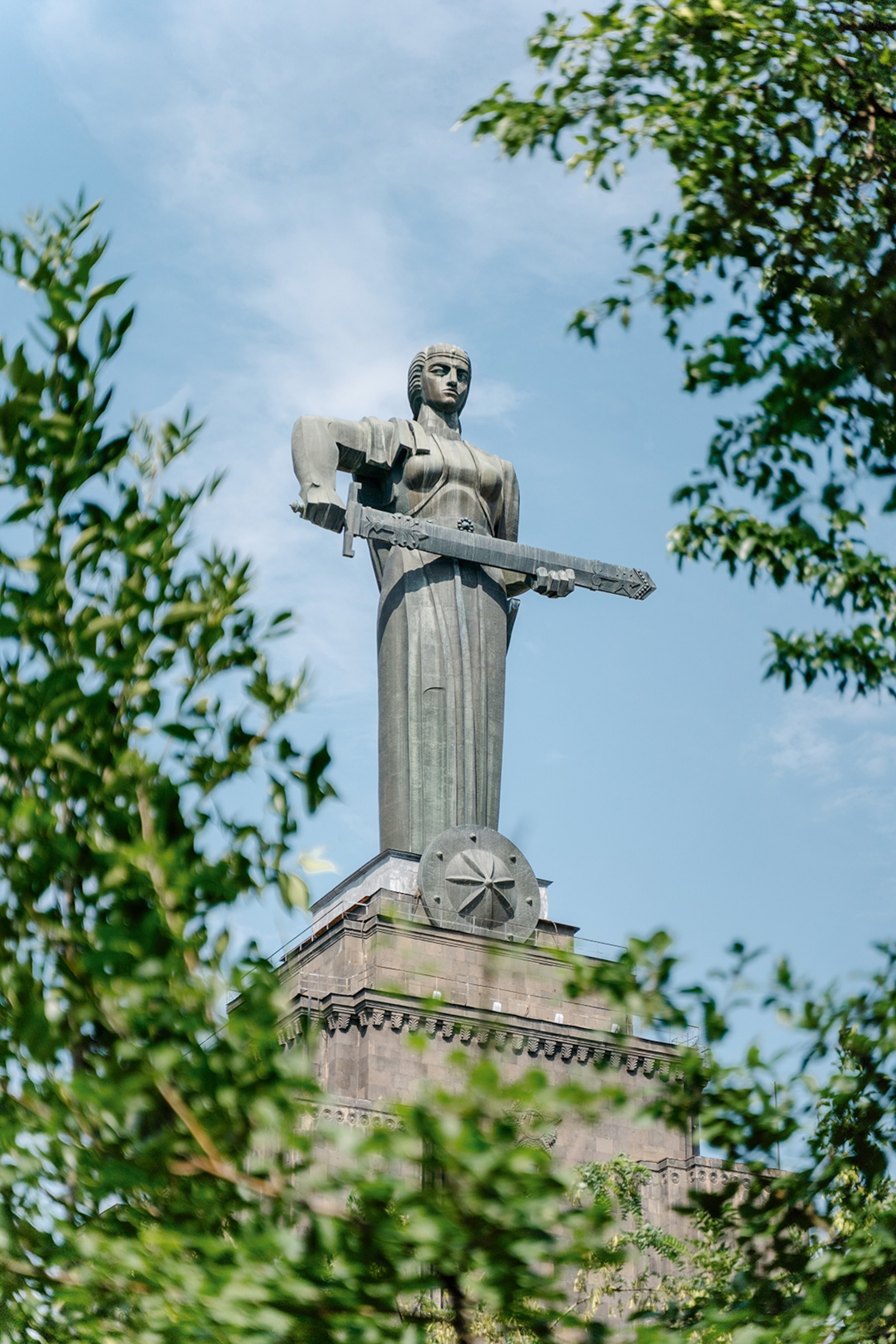The statue of a woman holding a sword sideways in her hands.