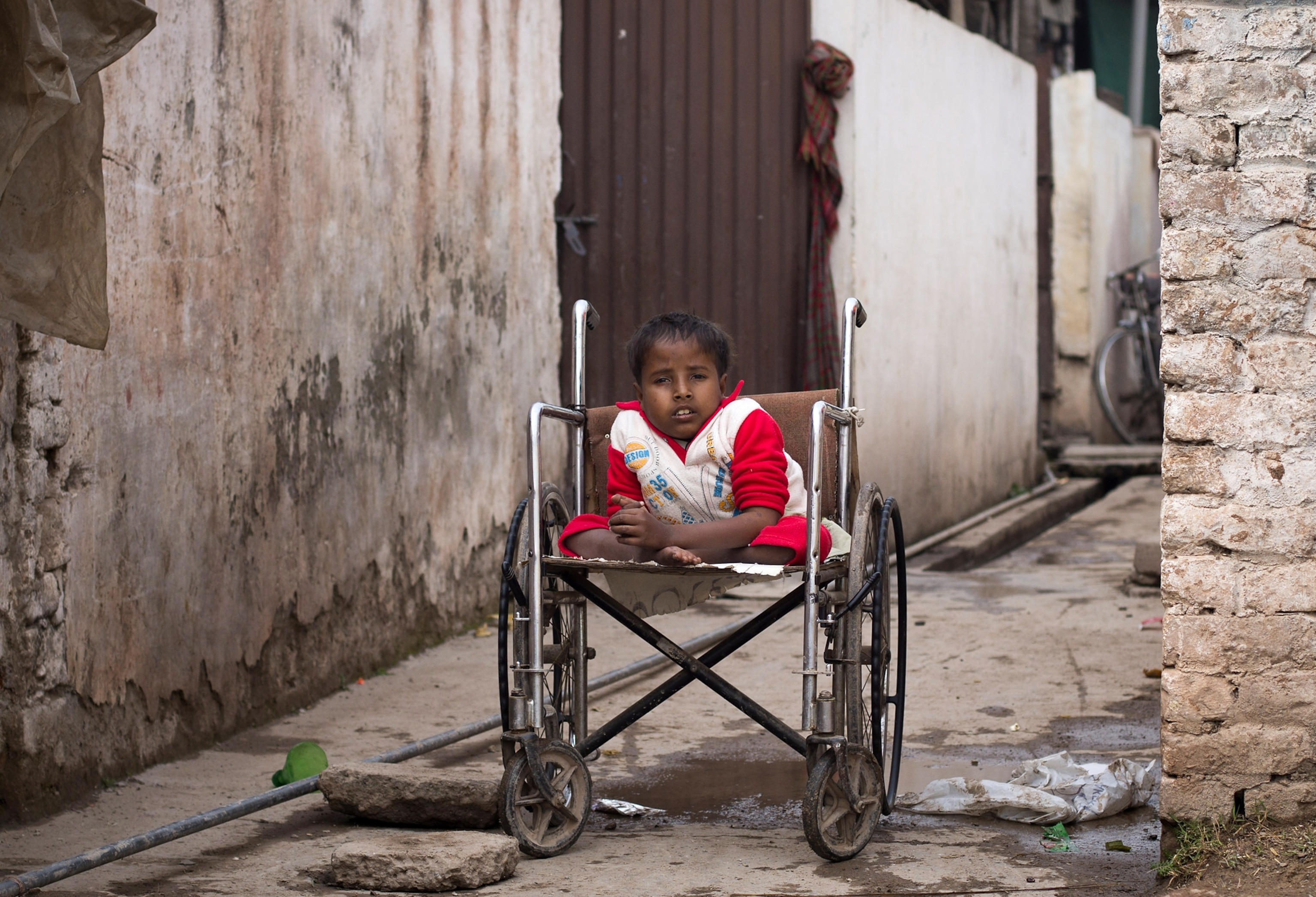 Sharjeel in wheelchair outside his home in Islamabad Pakistan
