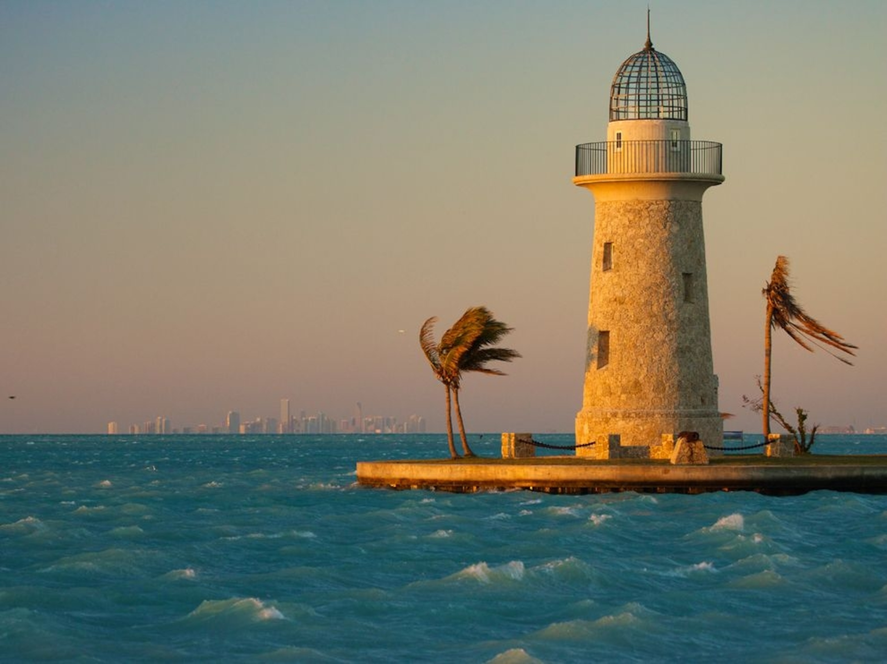 wind whipping waves past lighthouse