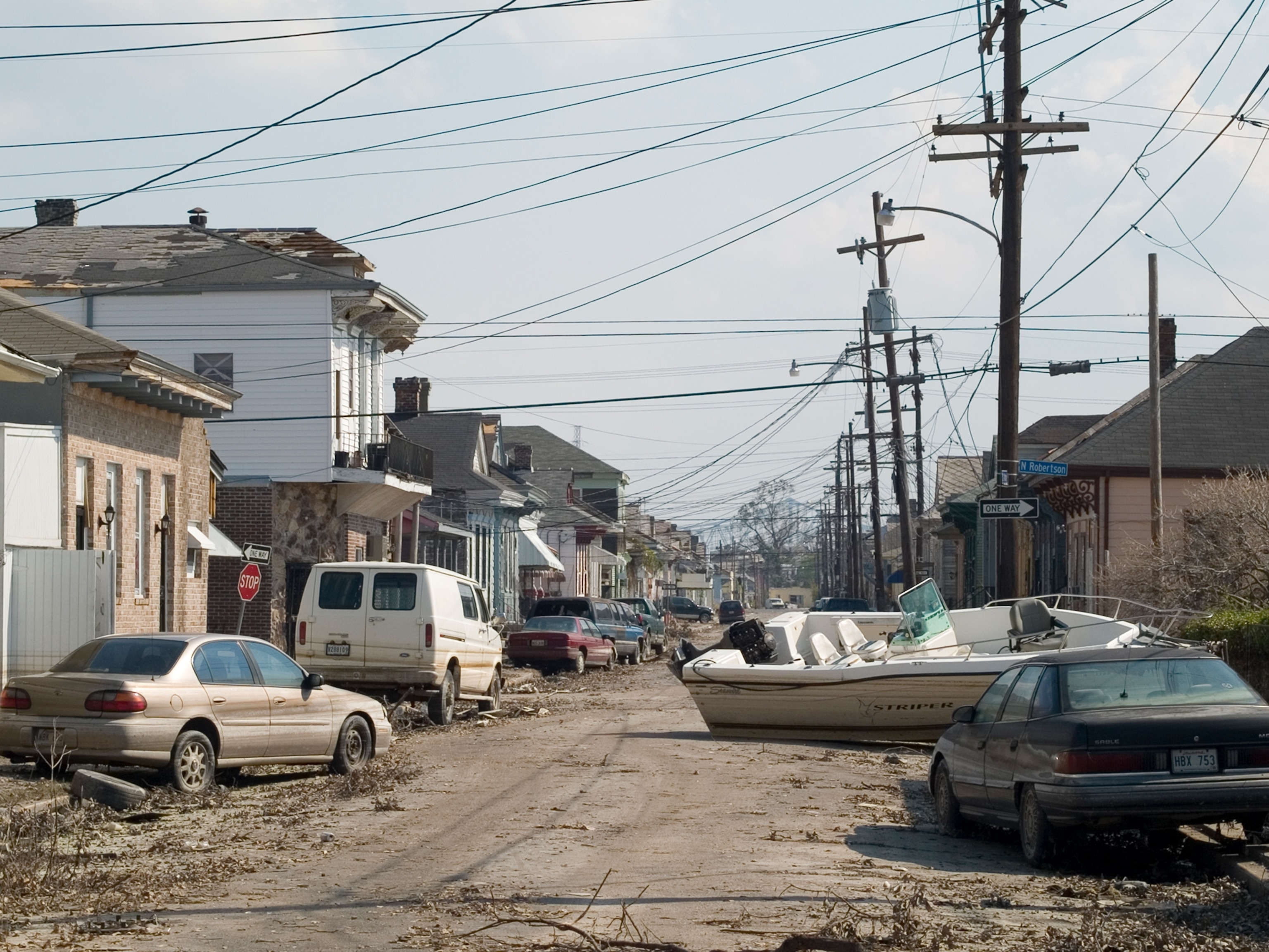 Abandoned cars and homes in New Orleans after Hurricane Katrina.