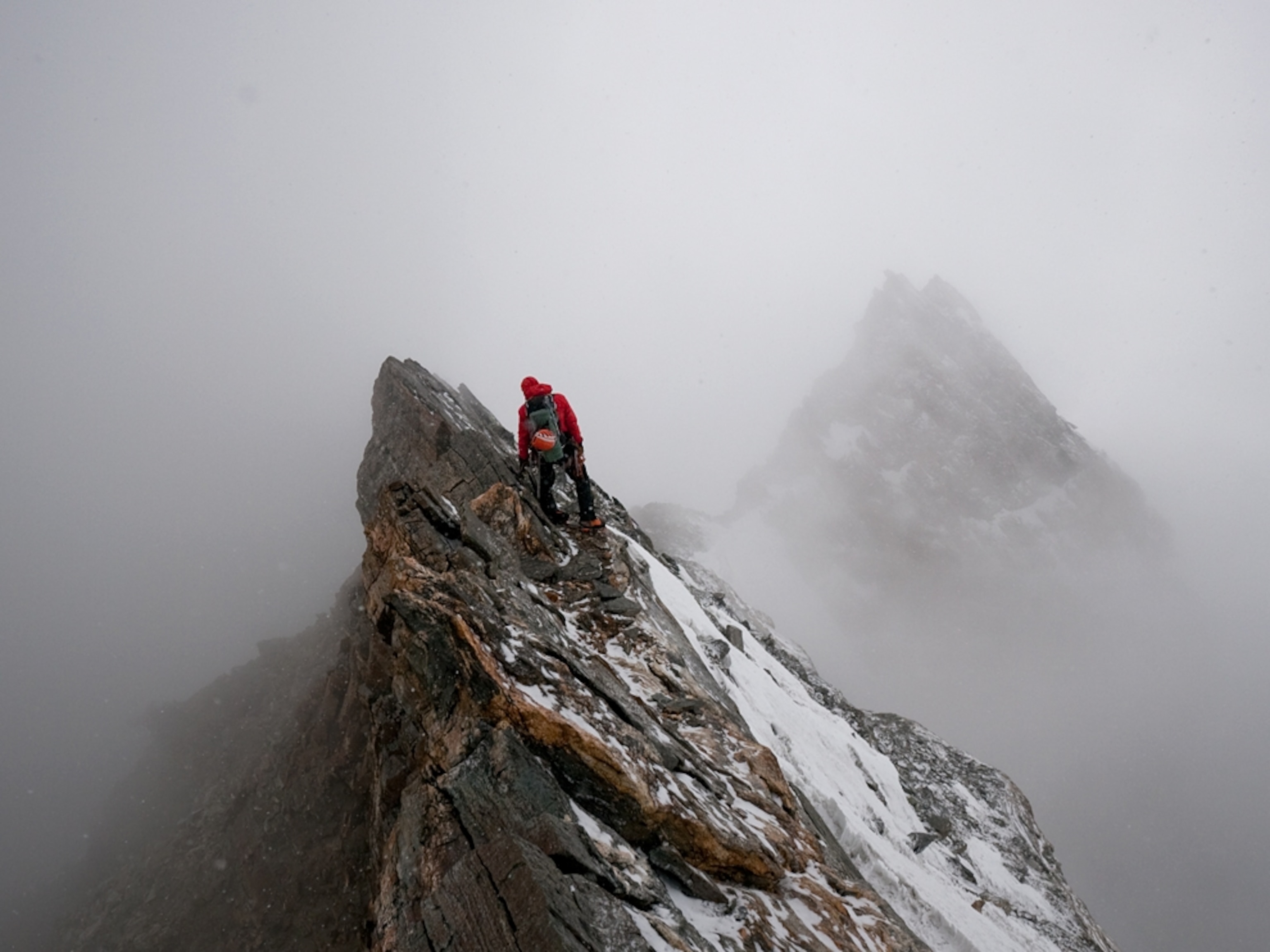 Alpine climber Ueli Steck searches for the best line of descent on a summit