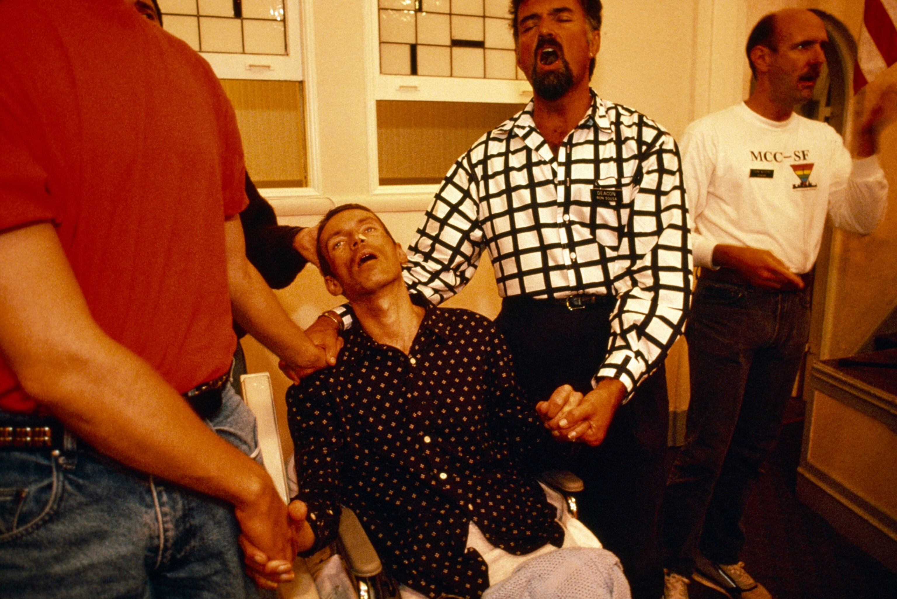 men singing prayers for a man with AIDS