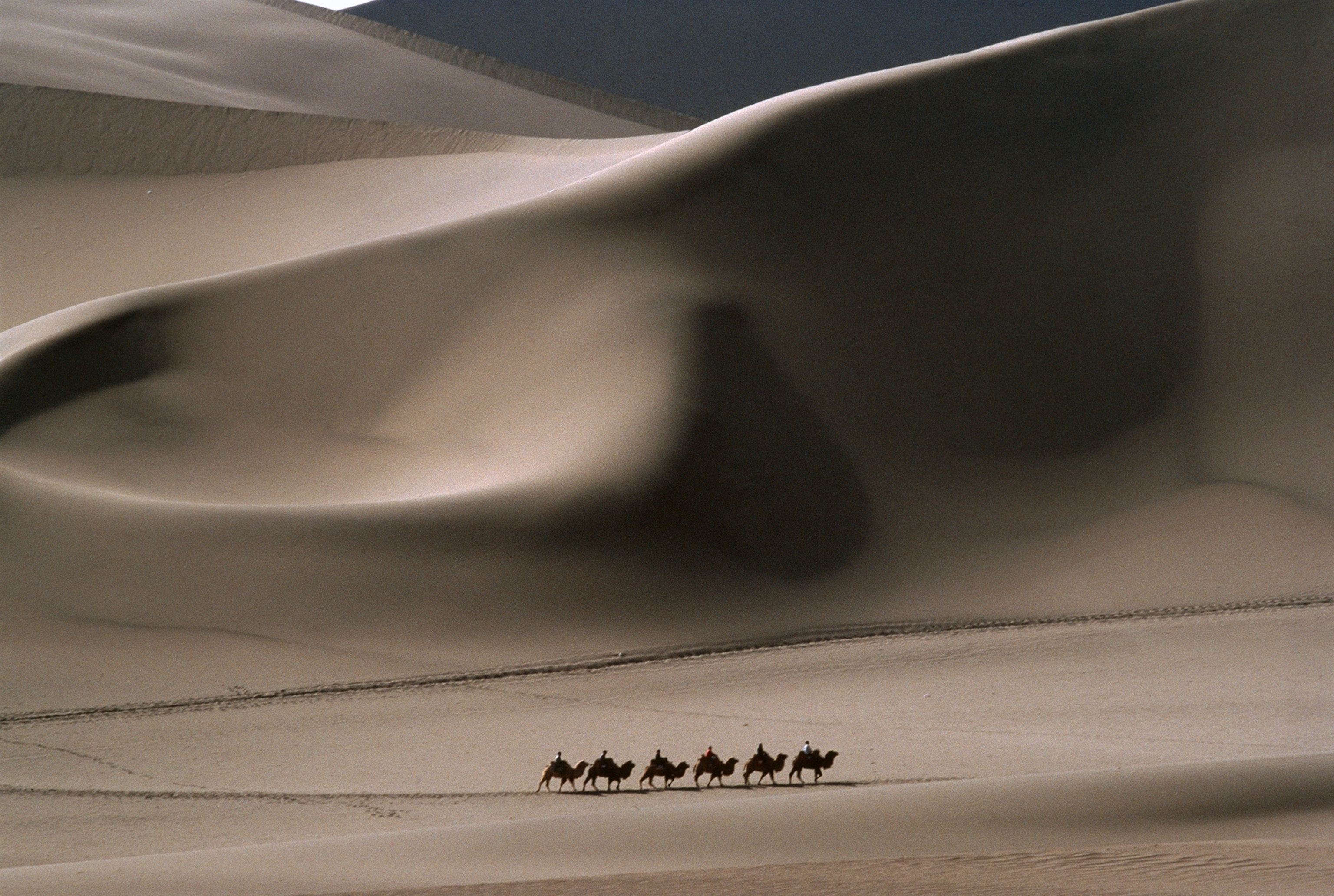 Here in the Taklimakan desert, visitors ride camelback as they have for centuries.