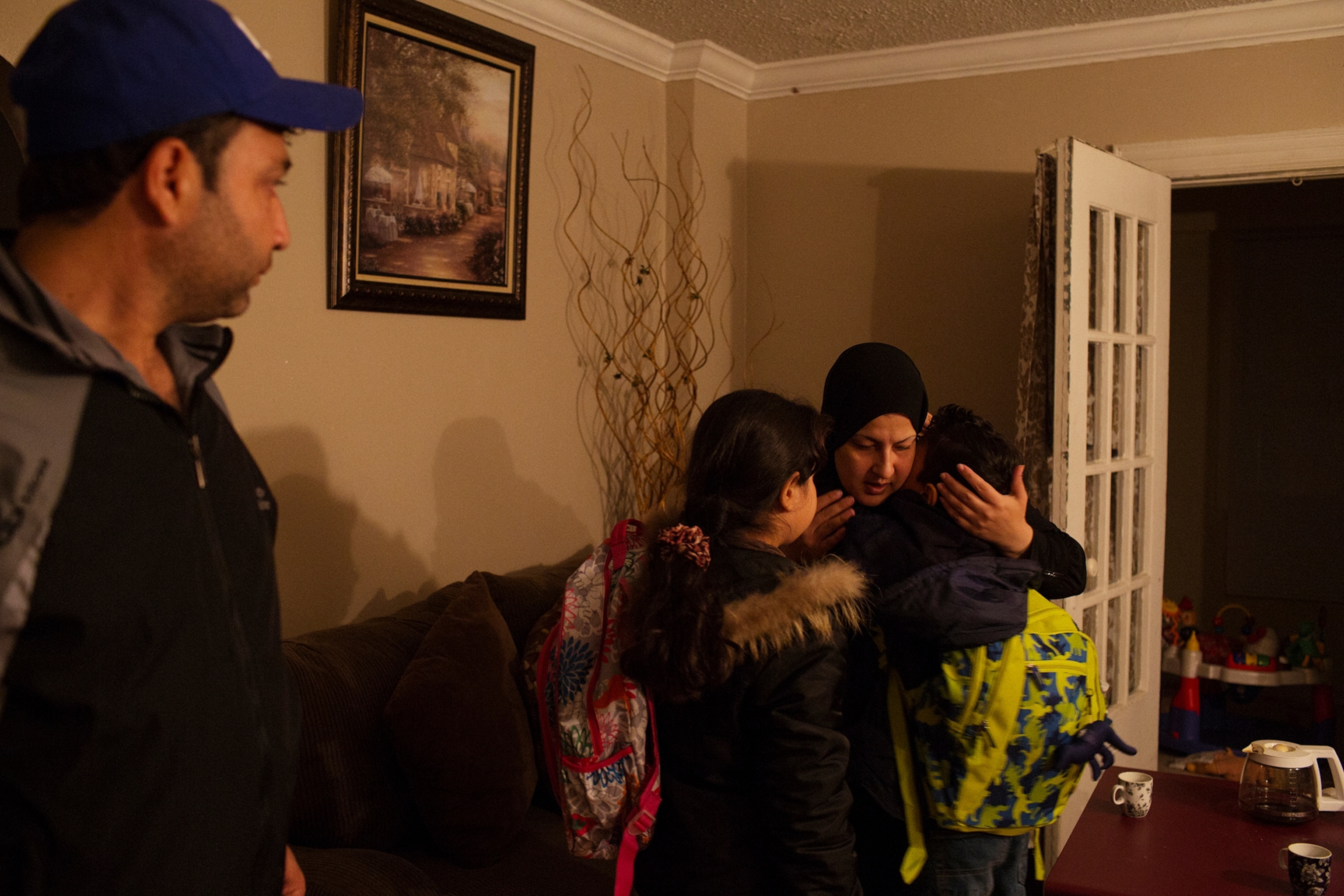 a woman hugging her children before they leave for school