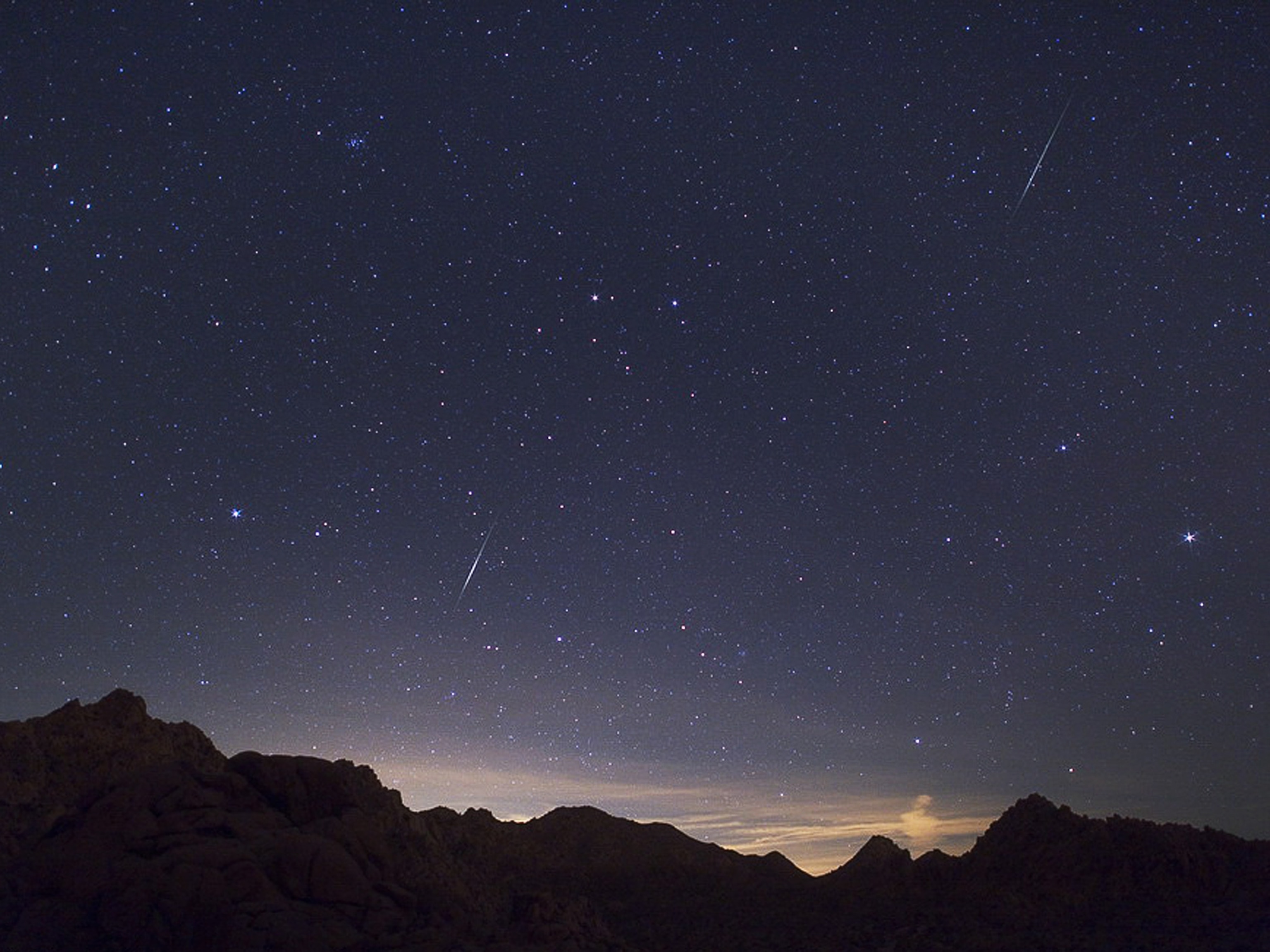 Two Quadrantid meteors streak over the Mojave Desert.