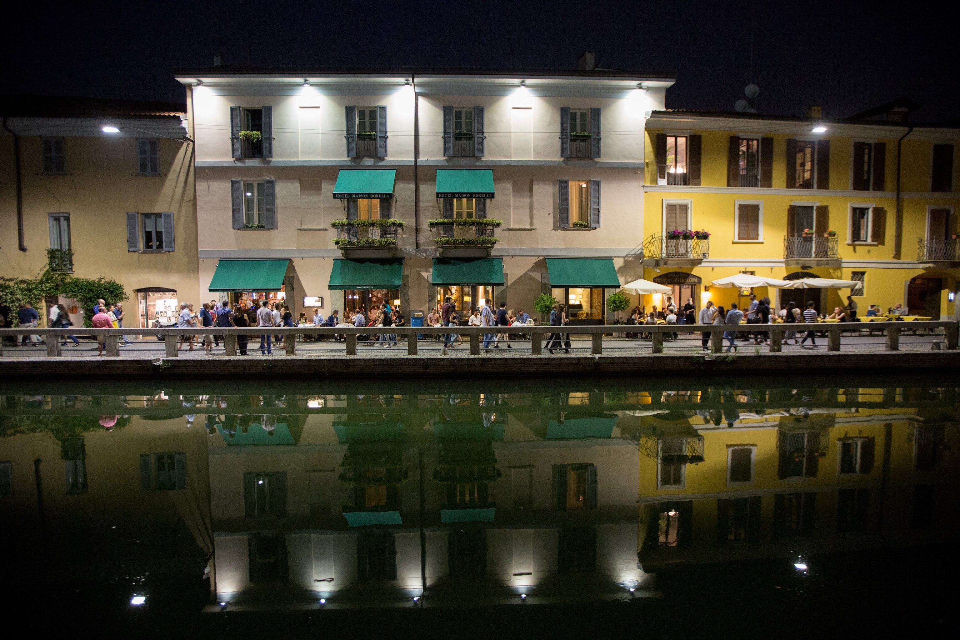 people strolling in the streets of the Navigli district in Milan, Italy