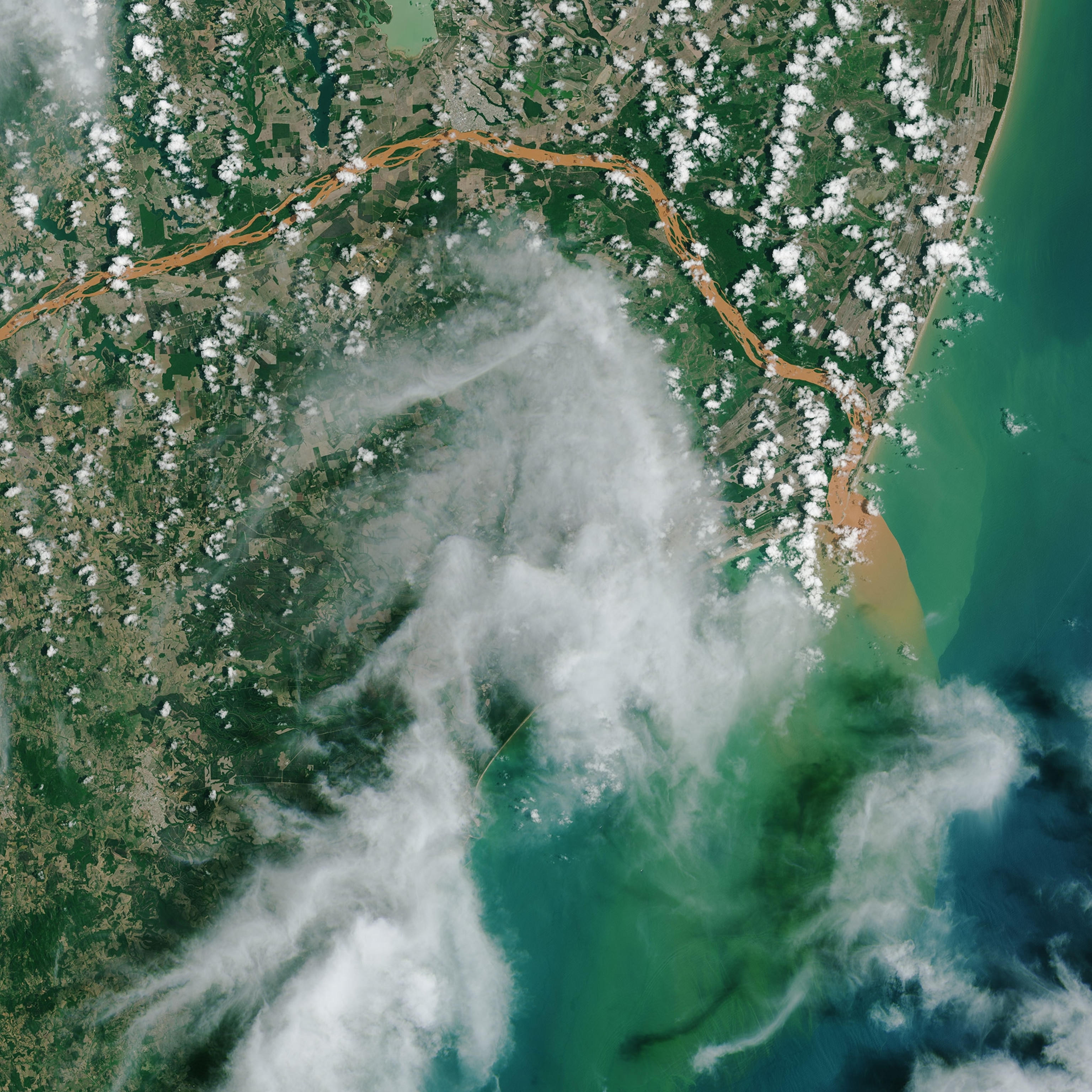 a contaminated river in Brazil spilling out in to the Atlantic Ocean