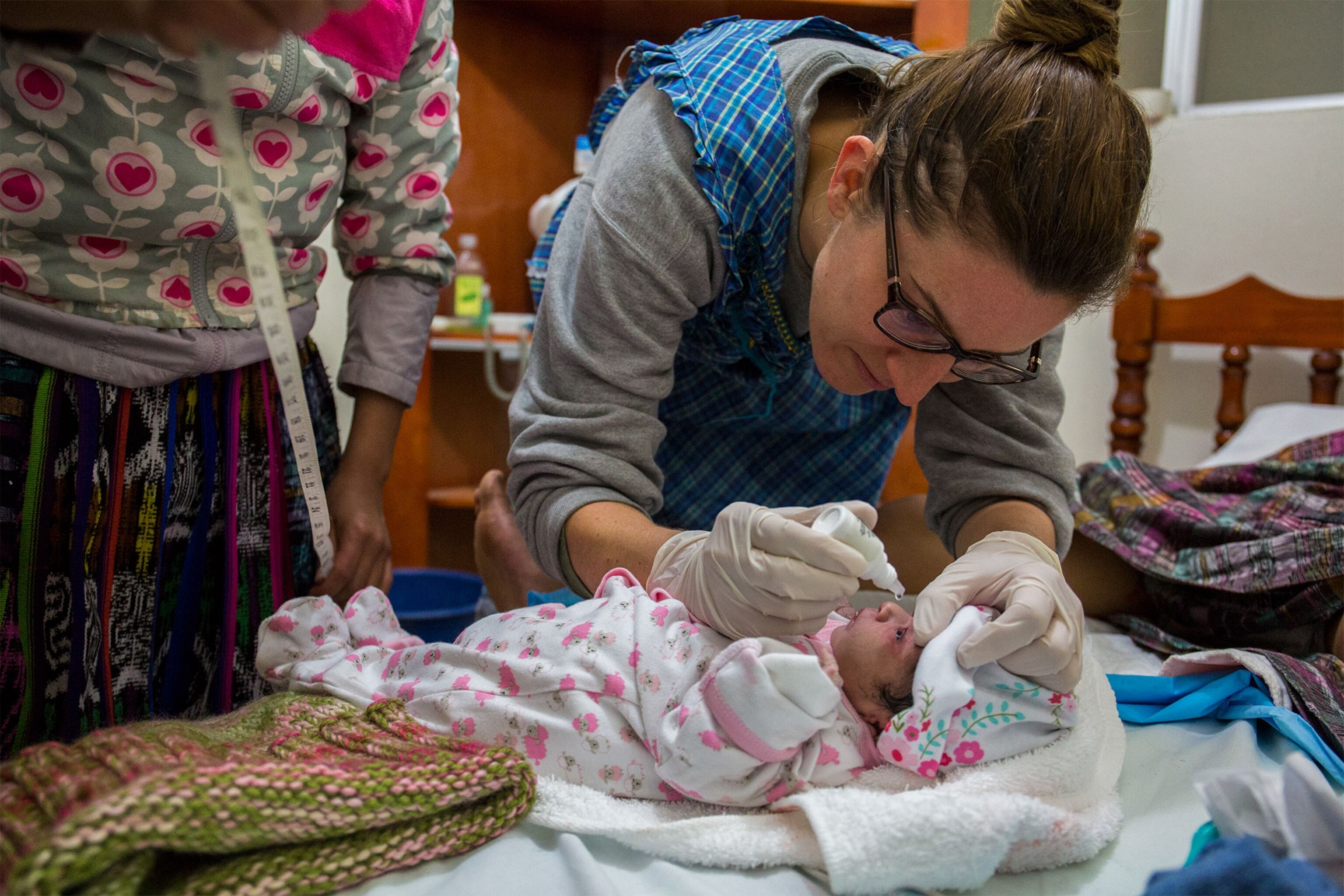 a midwife tending to a newborn in Guatemala