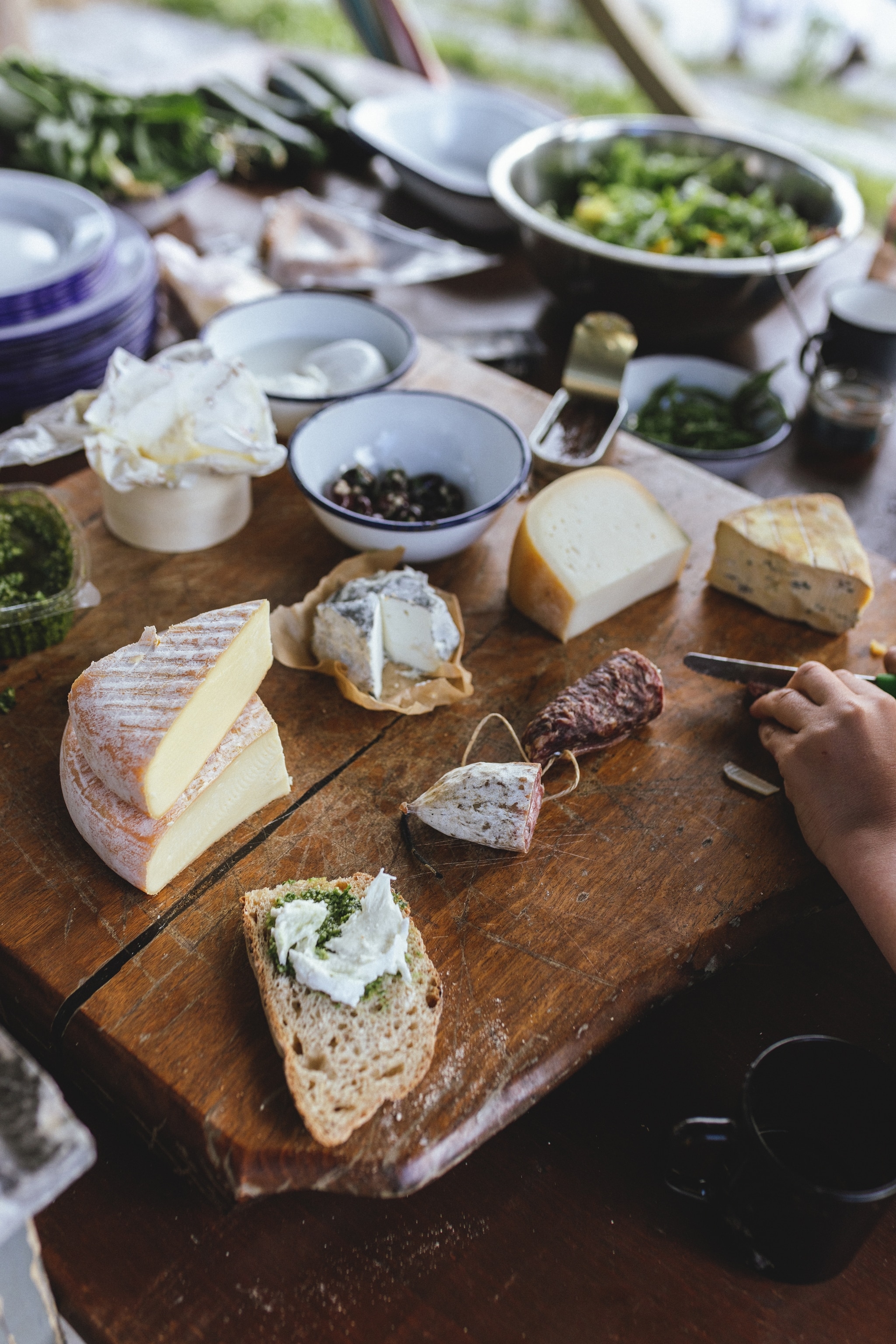Assorted cheeses and meats on a charcuterie board.