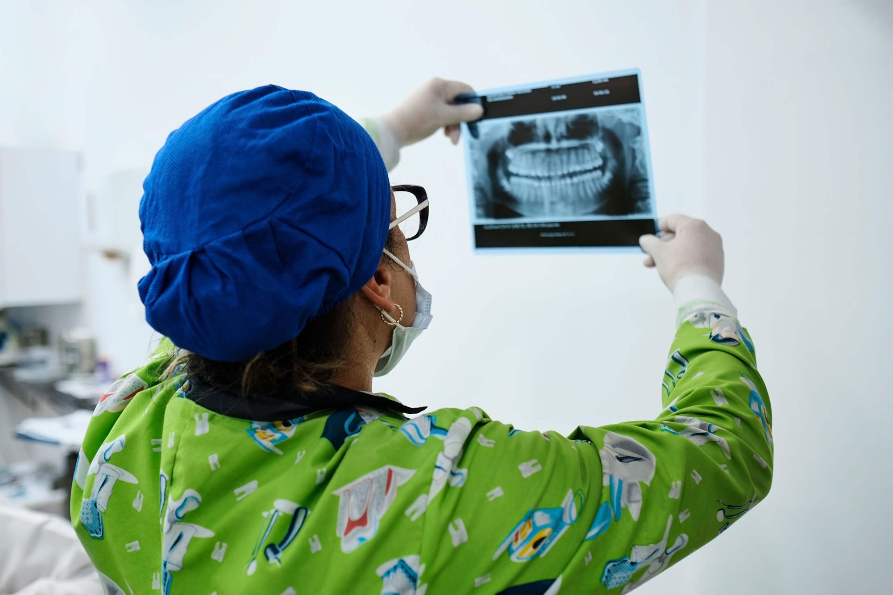 Dentist reviewing a printed x-ray image.