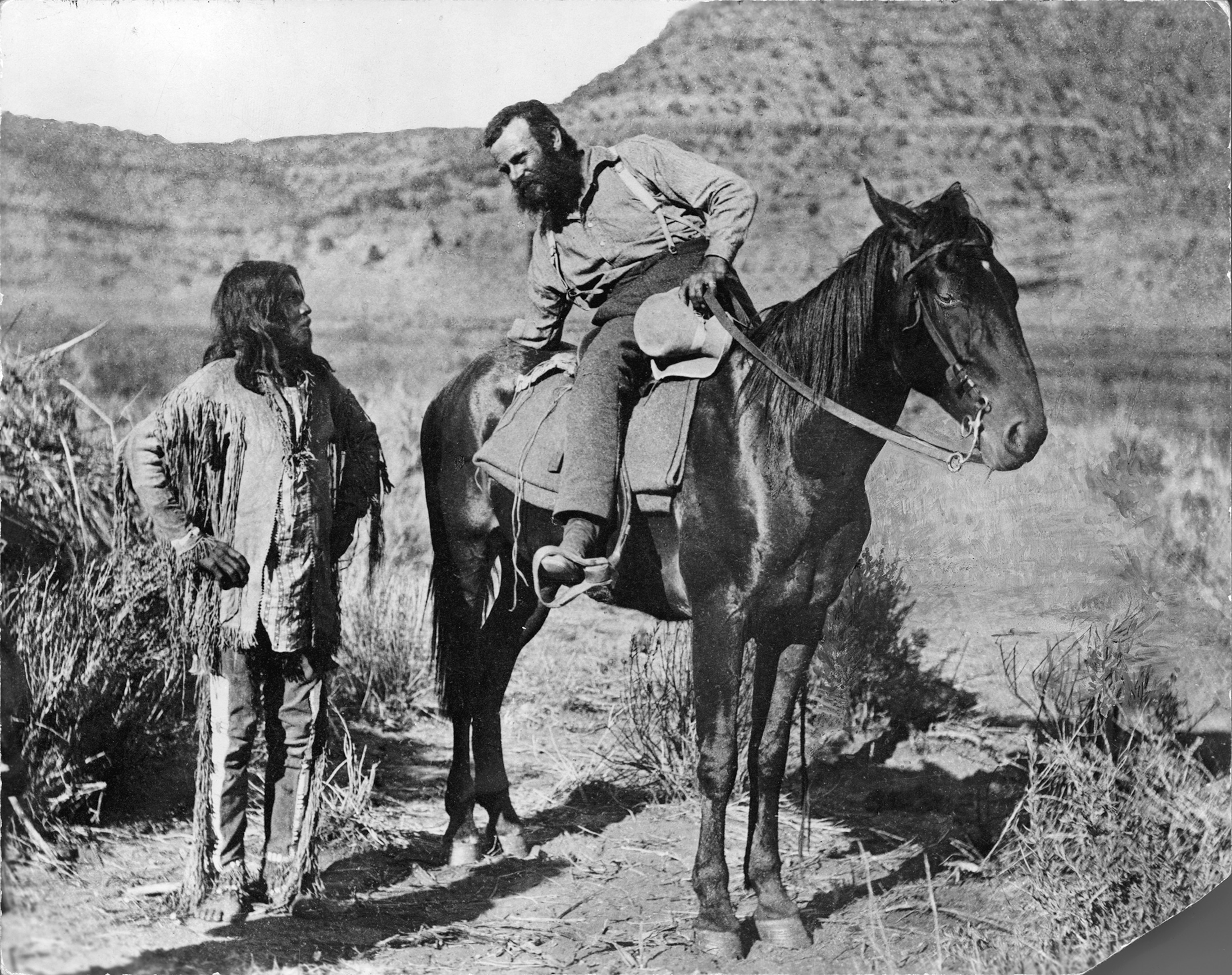 Explorer John Wesley Powell talks with a Paiute Indian.
