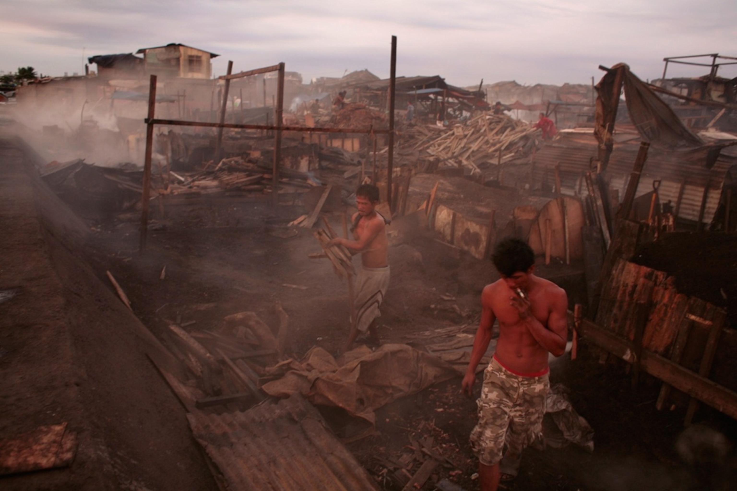 Workers in Manila’s charcoal-producing slums