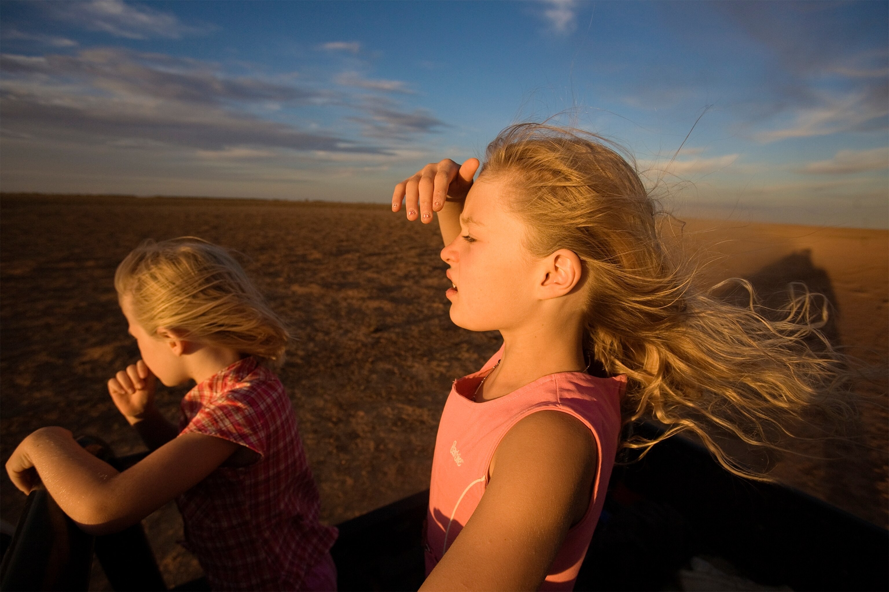 An aerial photo of a tractor harvesting wheat.