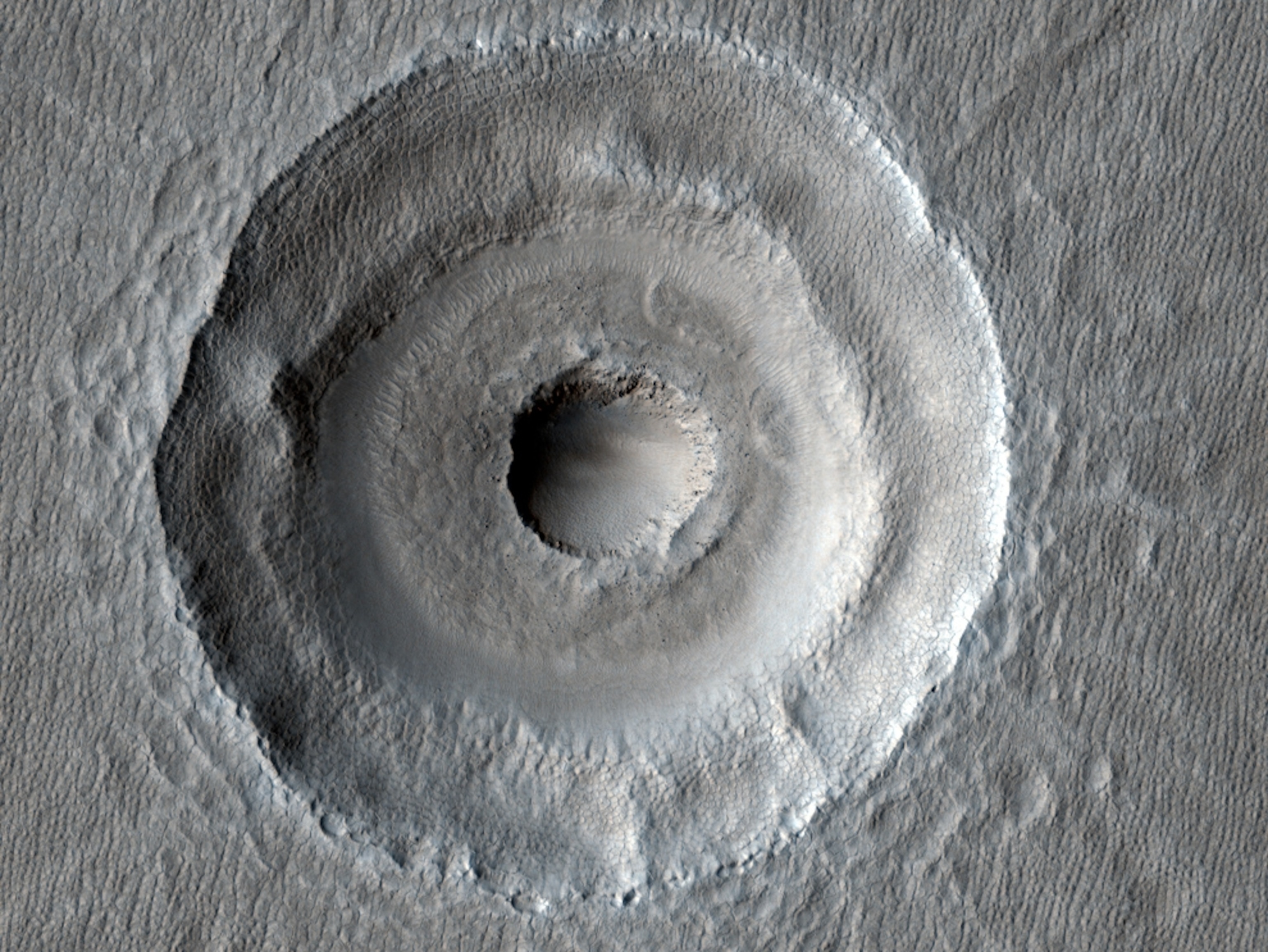 Satellite picture of an oddly shaped impact crater on Mars.