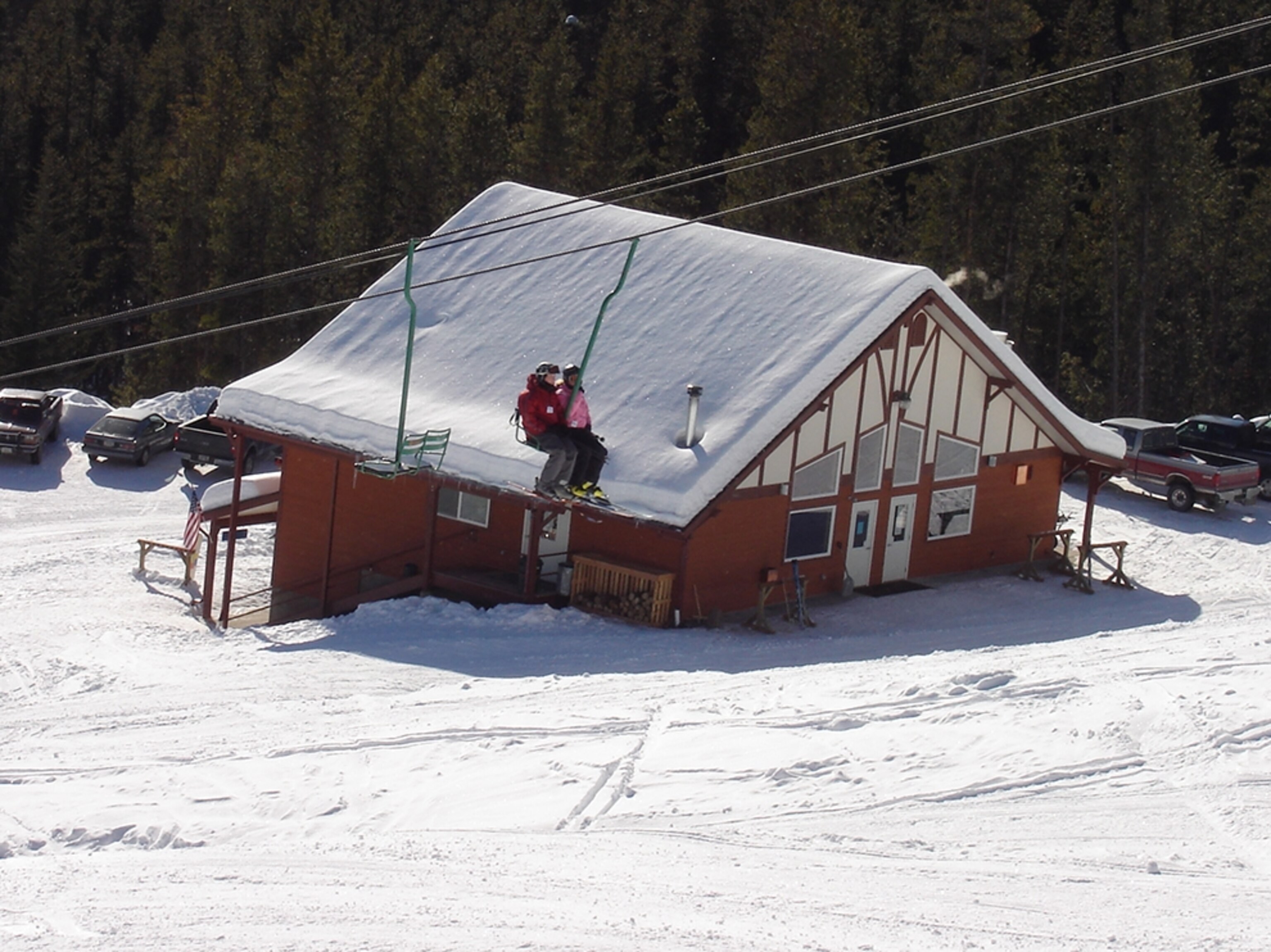 skiers taking the chairlift up Turner Mountain ski resort, Montana