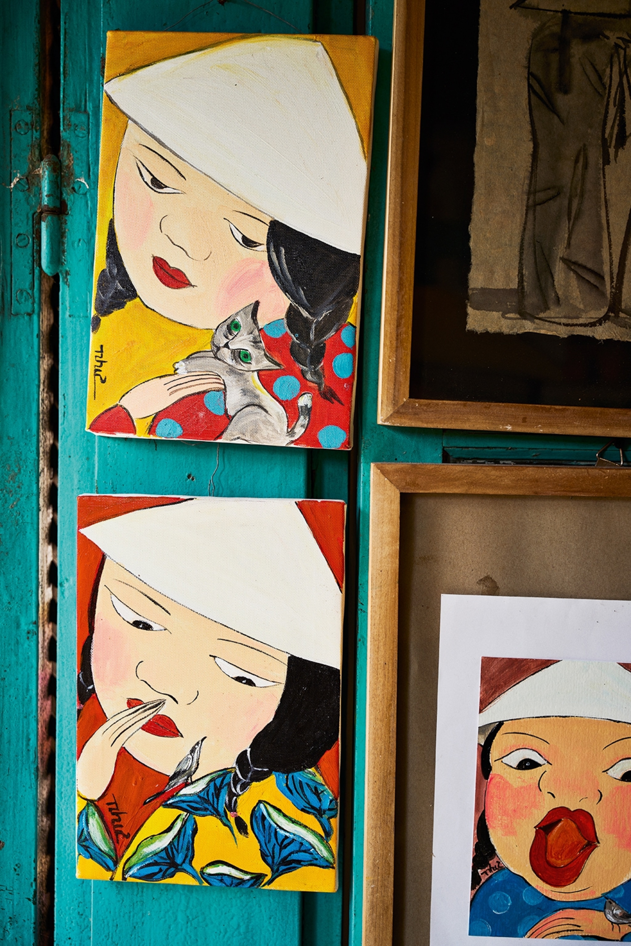 A close-up of paintings showing abstract portrait of young women.