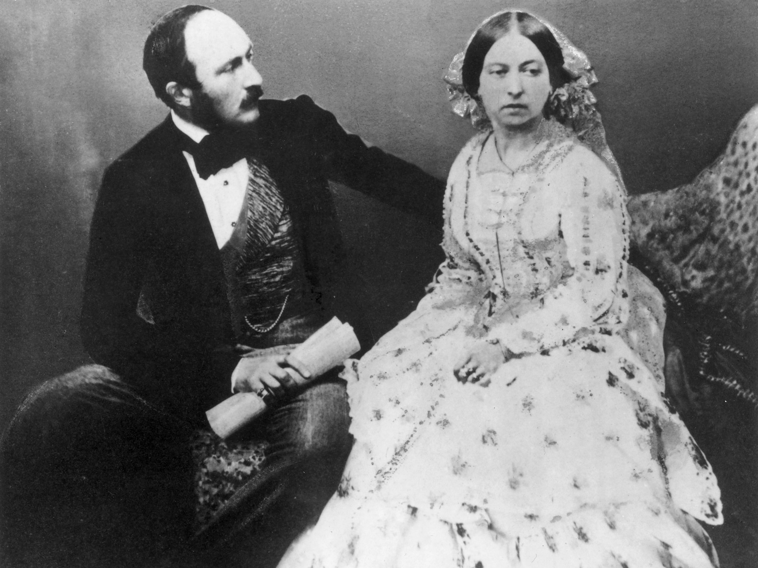 A portrait of a man and a woman sitting next to one another