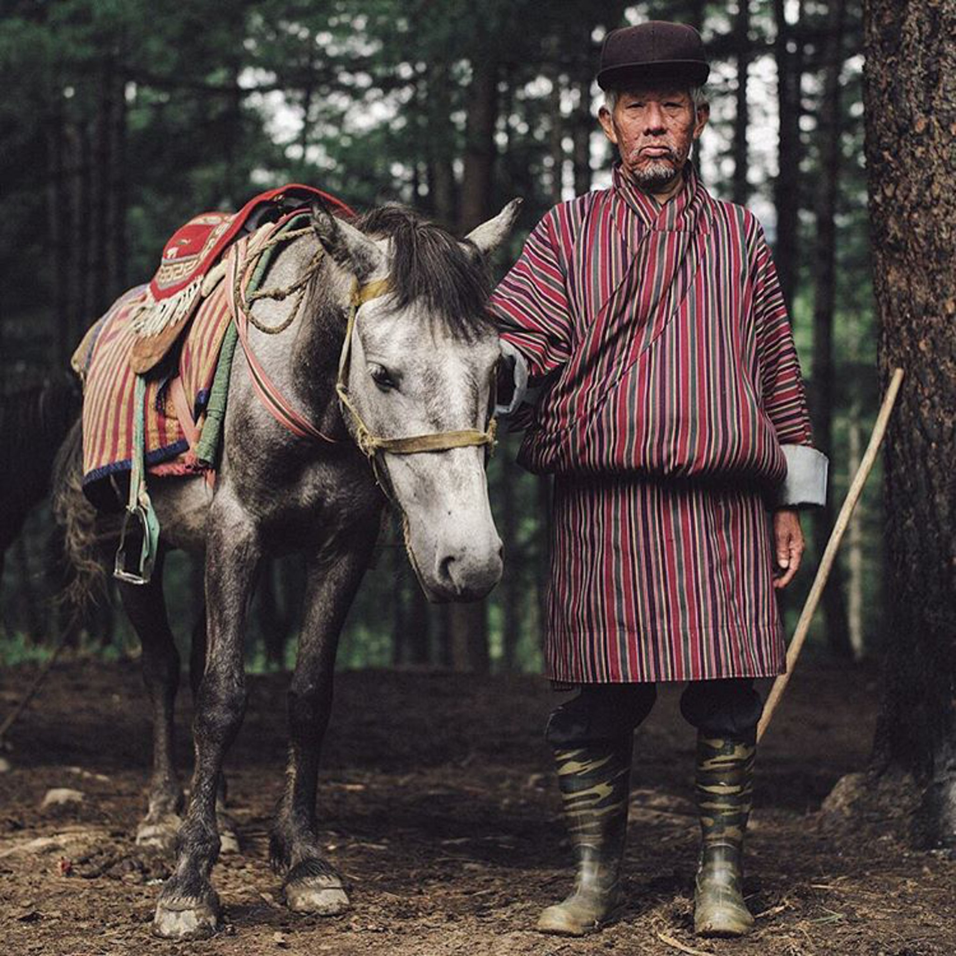 a man standing next to a horse