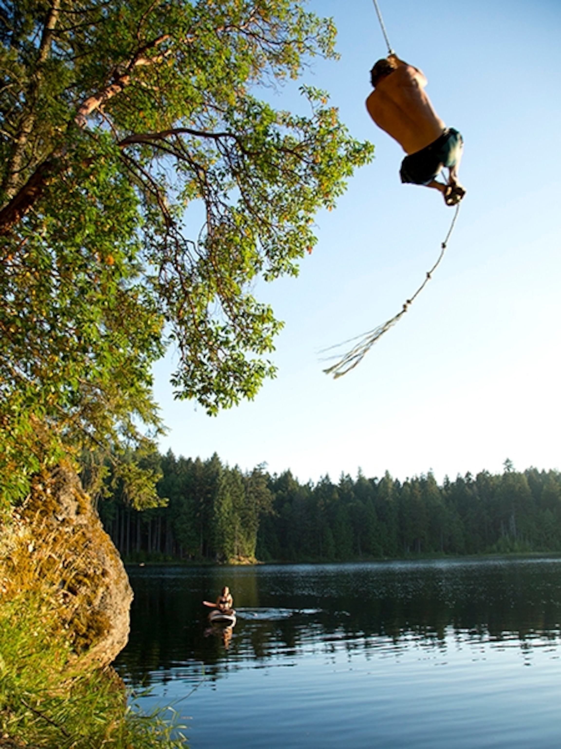 man on a swing in Salt Spring Island, British Columbia, Canada