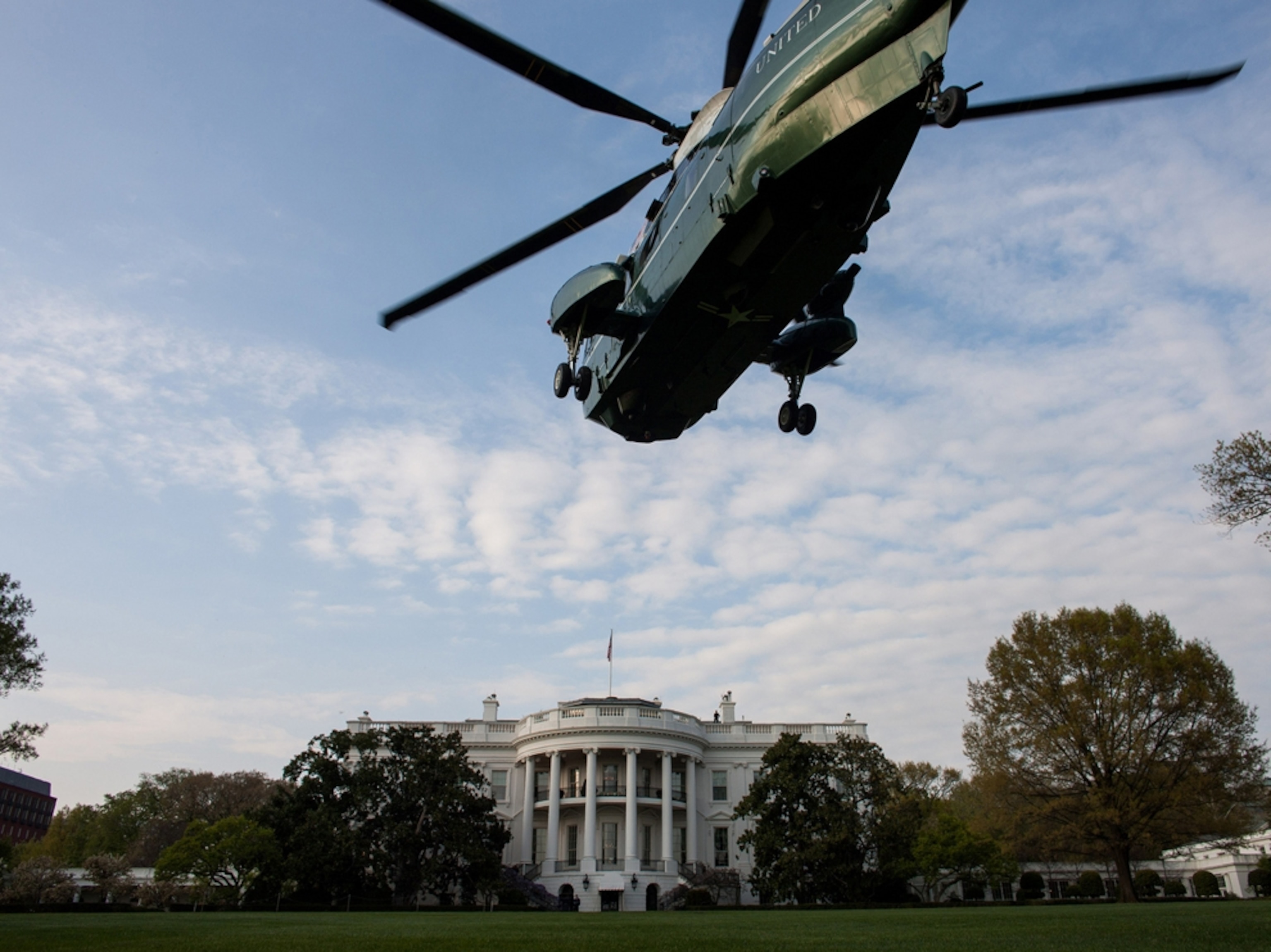 a helicopter landing at the White House