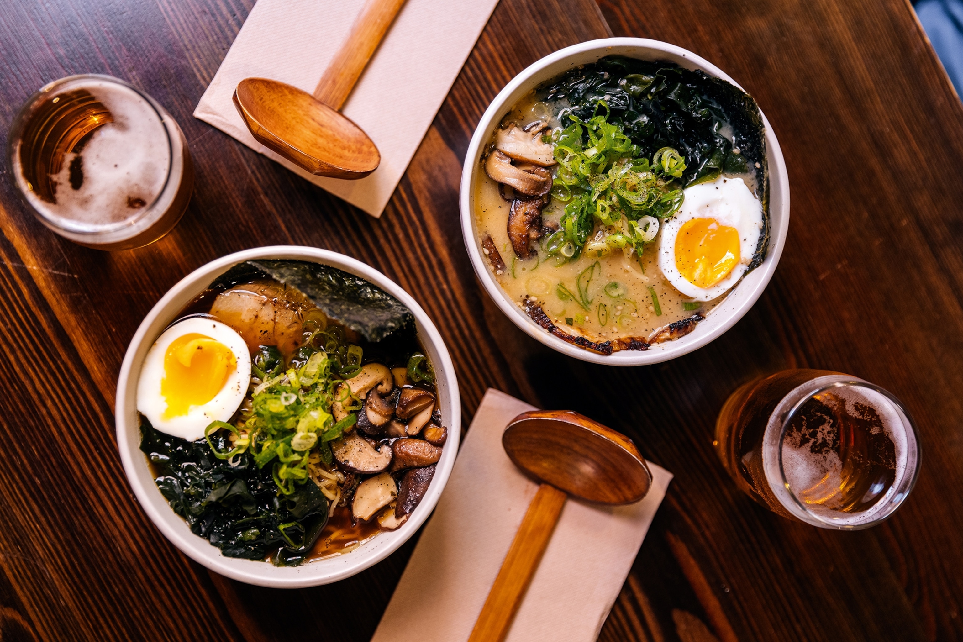 Bowls of classic ramen with an array of toppings, including nori, egg and spring onion.