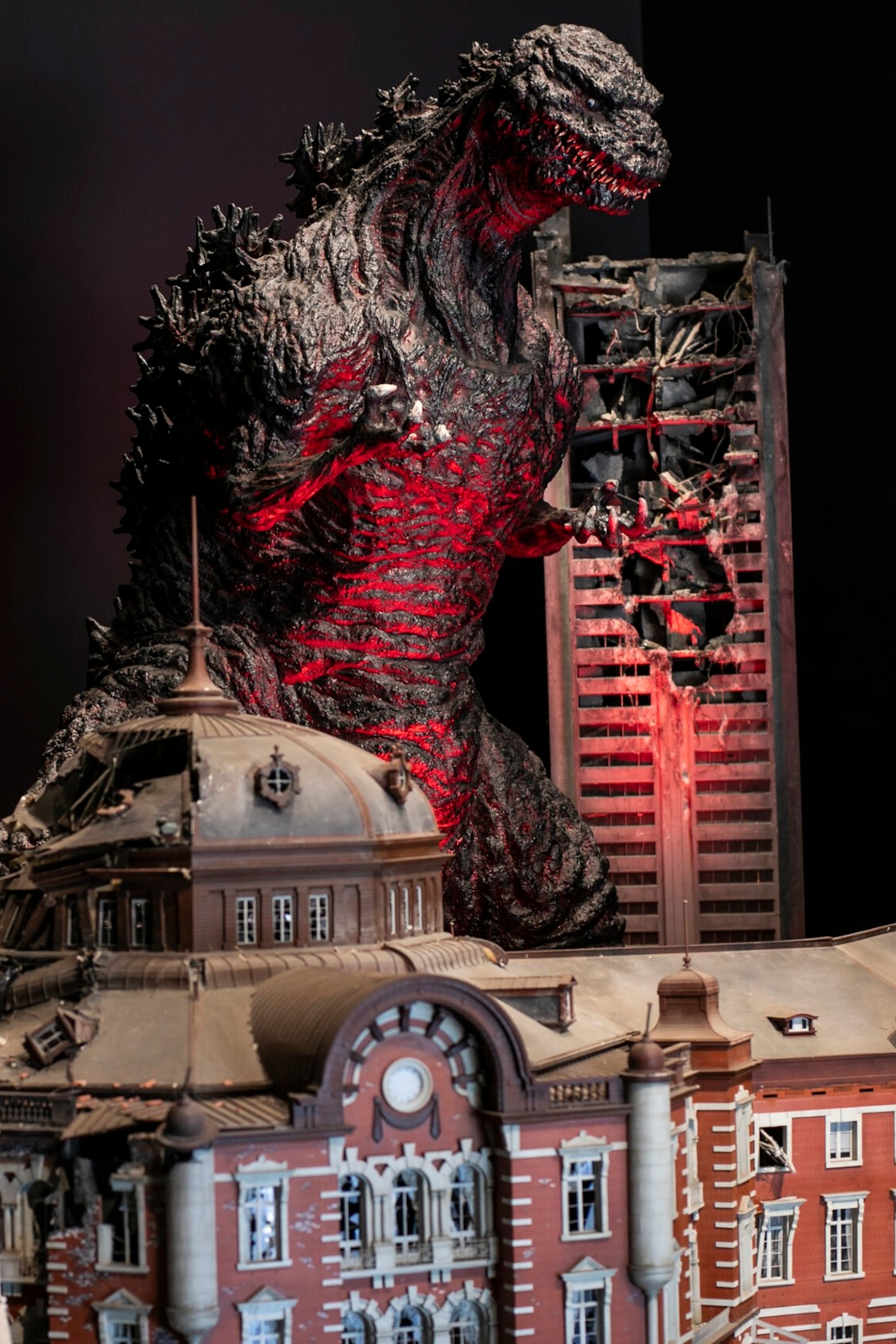 The interior of a Godzilla installation in a museum featuring an oversized reproduction of the creature.