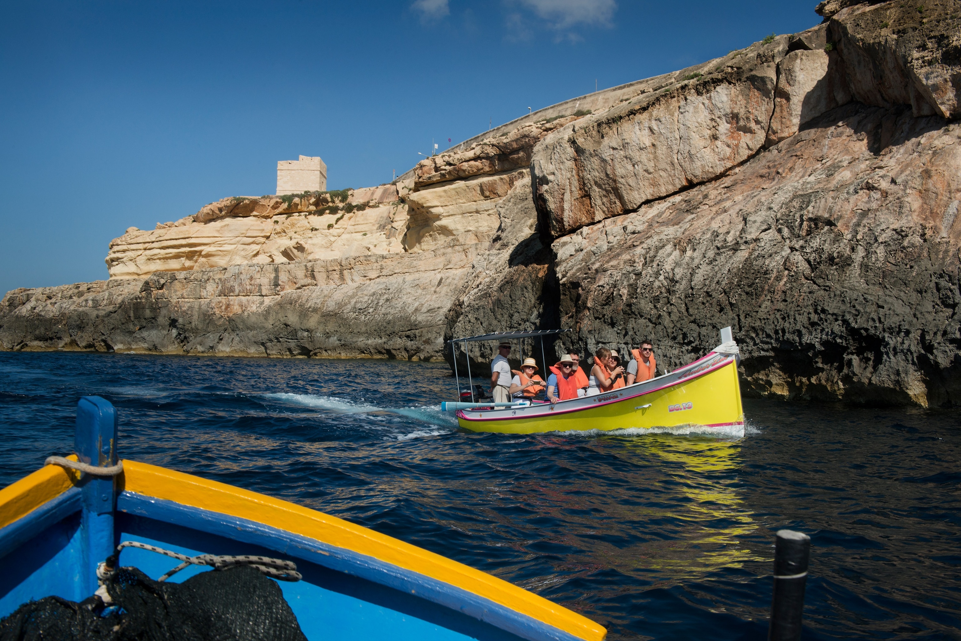 boats of tourists on a tour near the Azure Window, Malta