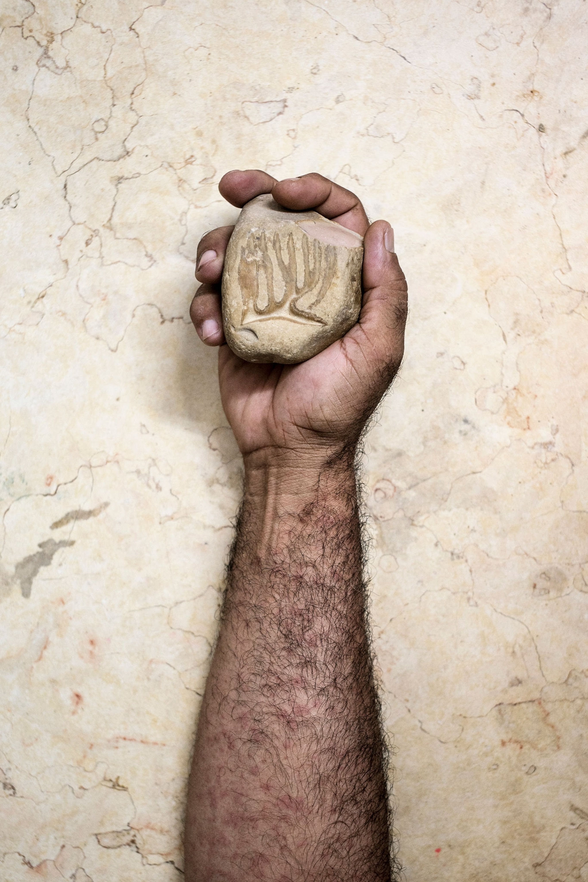 Nour al-Dein Zaki, a geologist, holding a stone