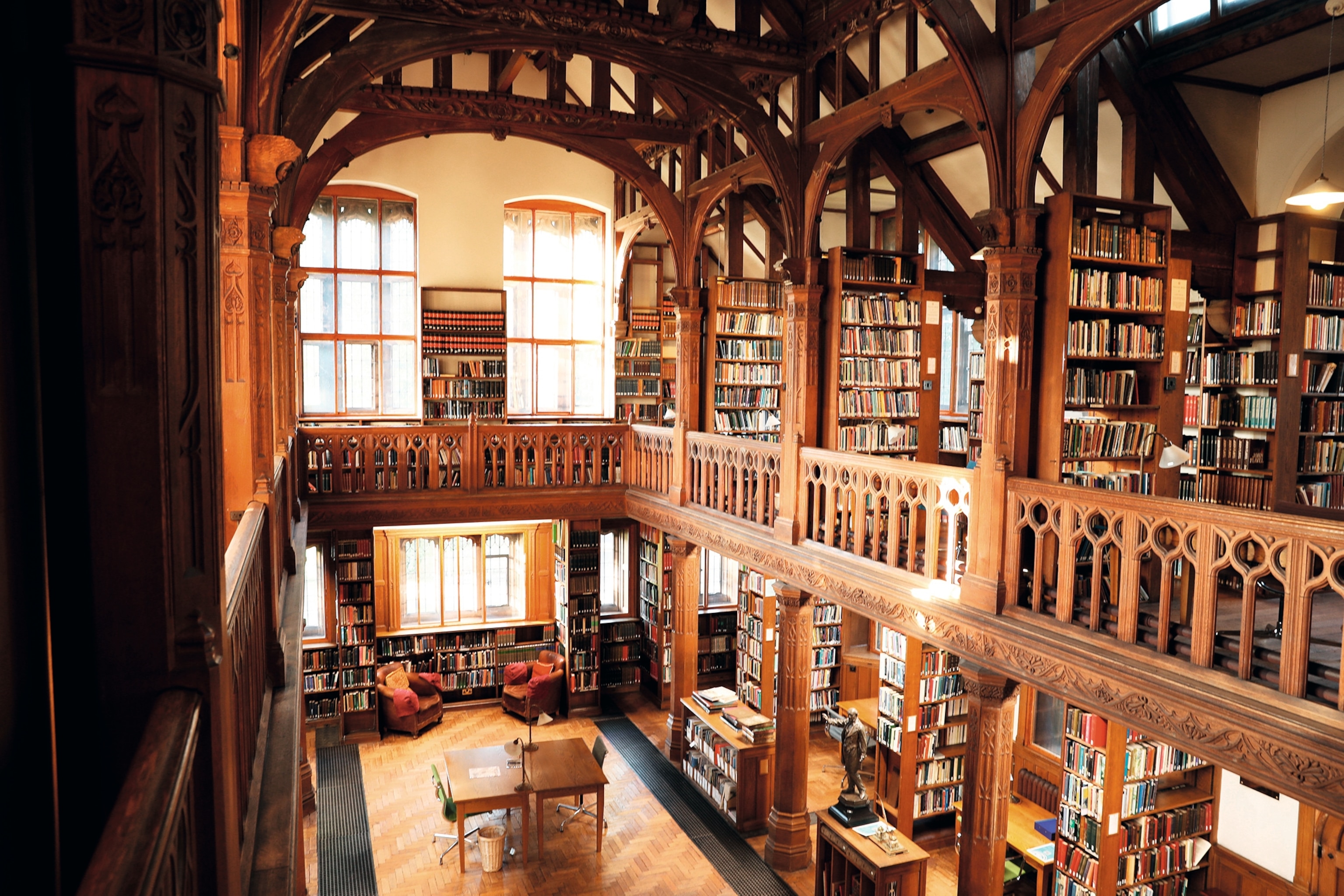 The Theology Room at Gladstone Library, featuring two levels of floor-to-ceiling bookshelves filled with books.