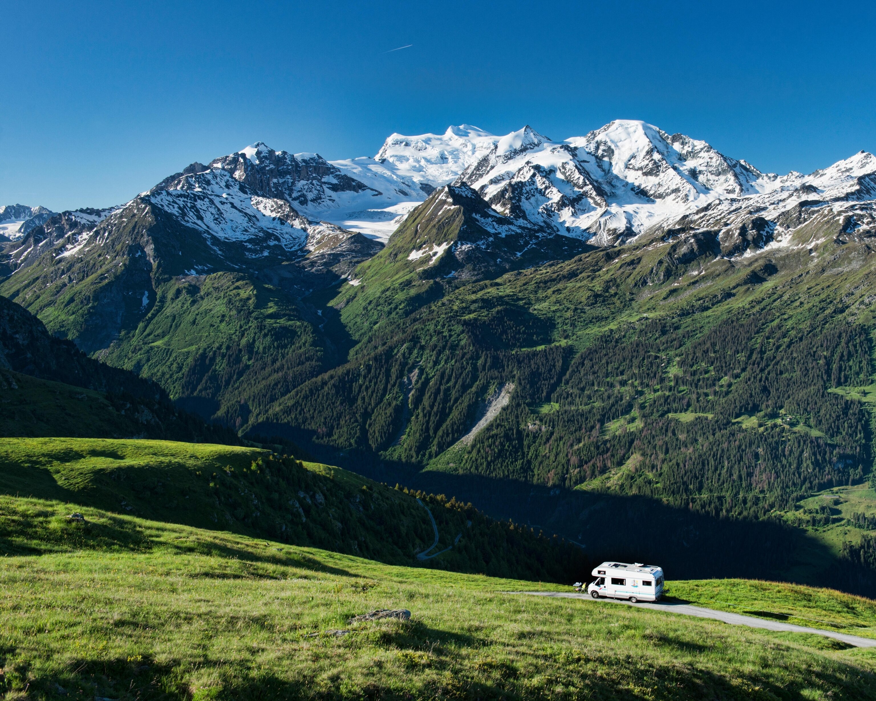 An RV is parked overlooking the Grand Combin.
