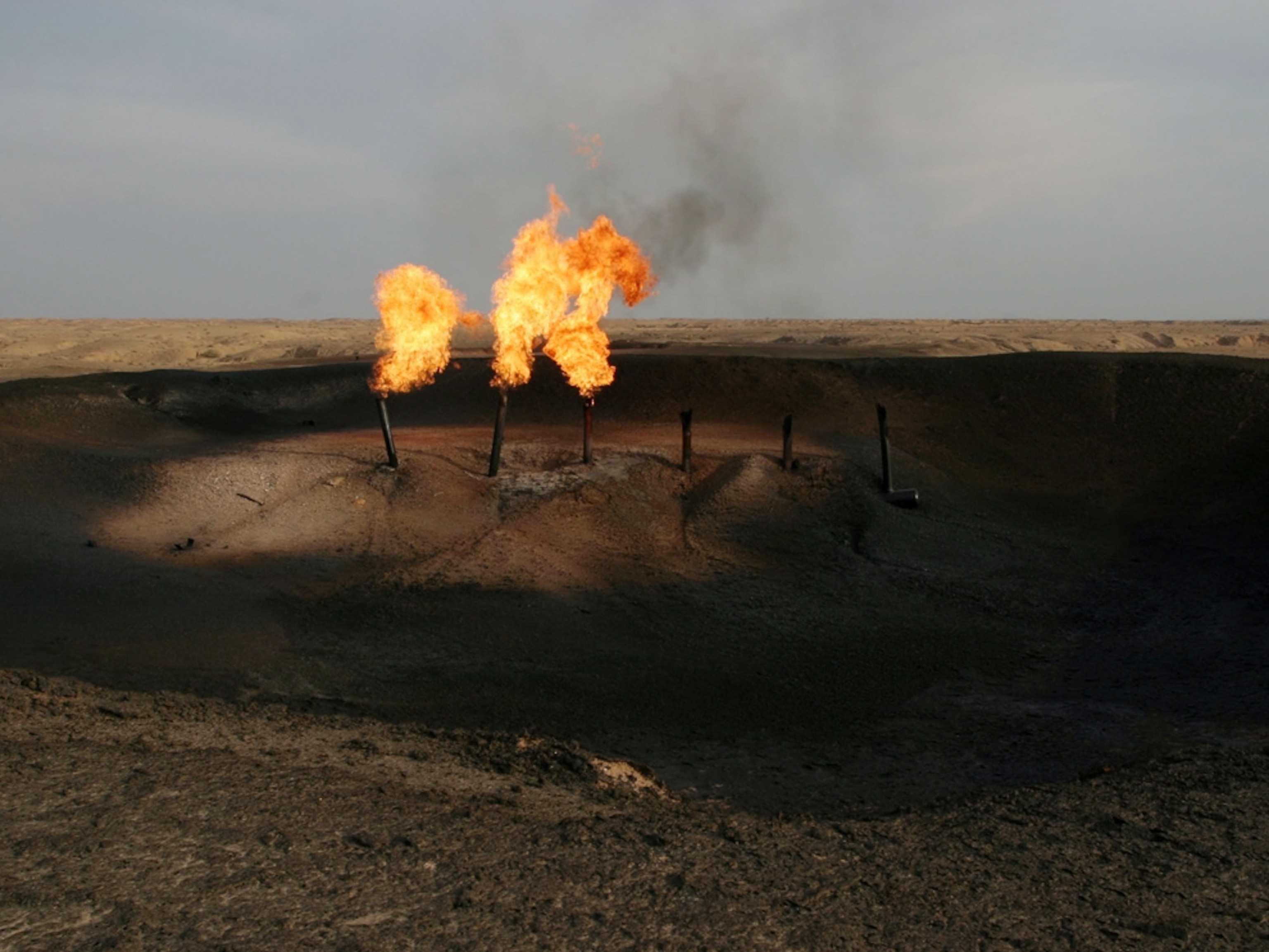Gas flares from pipes in an oil field near Baghdad, Iraq.In this picture taken Friday, Dec. 25, 2009, the al-Fakkah oil field is seen in Maysan province, south of Baghdad, Iraq. An Iraqi oil official says an oil well that was temporarily seized by Iranian troops is Iraqi and that a dispute over a poorly marked border was to blame. A three-day standoff between Iraq and Iran followed the Dec. 17 takeover by Iranian troops of well No. 4 at al-Fakkah oil field along the two countries' disputed border in southern Maysan province. (AP Photo/Alaa al-Marjani)