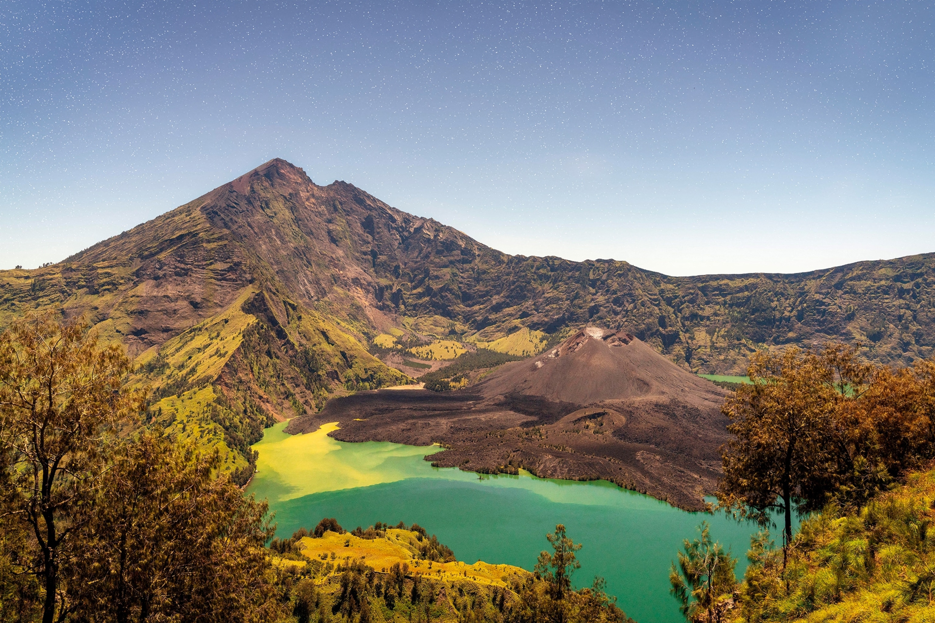 A grand, high-altitude lake at the foot of a volcano.
