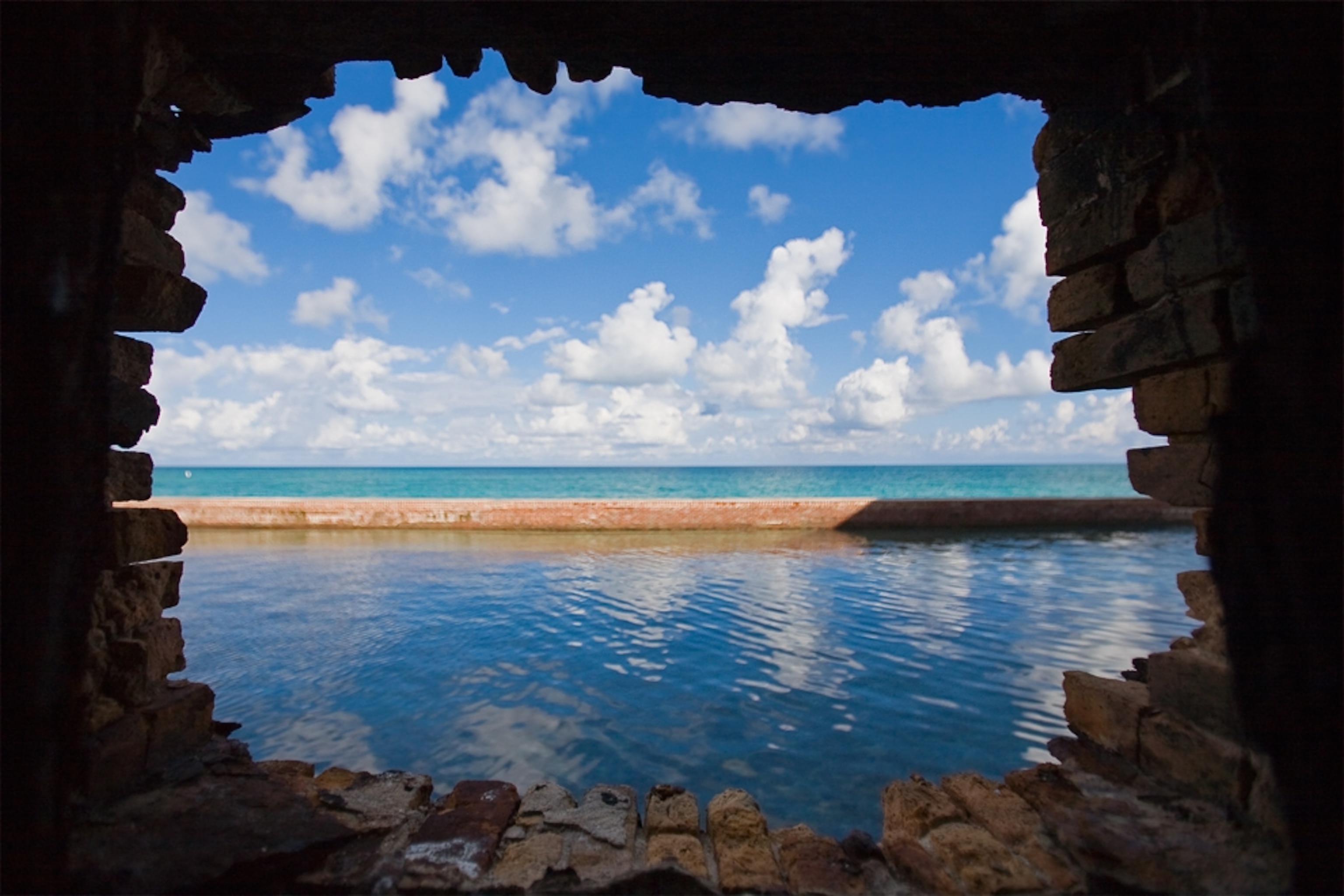 Ocean and sky view through fort wall of Dry Tortugas National Park, one of the U.S. national parks that may be threatened by the Gulf oil spill.