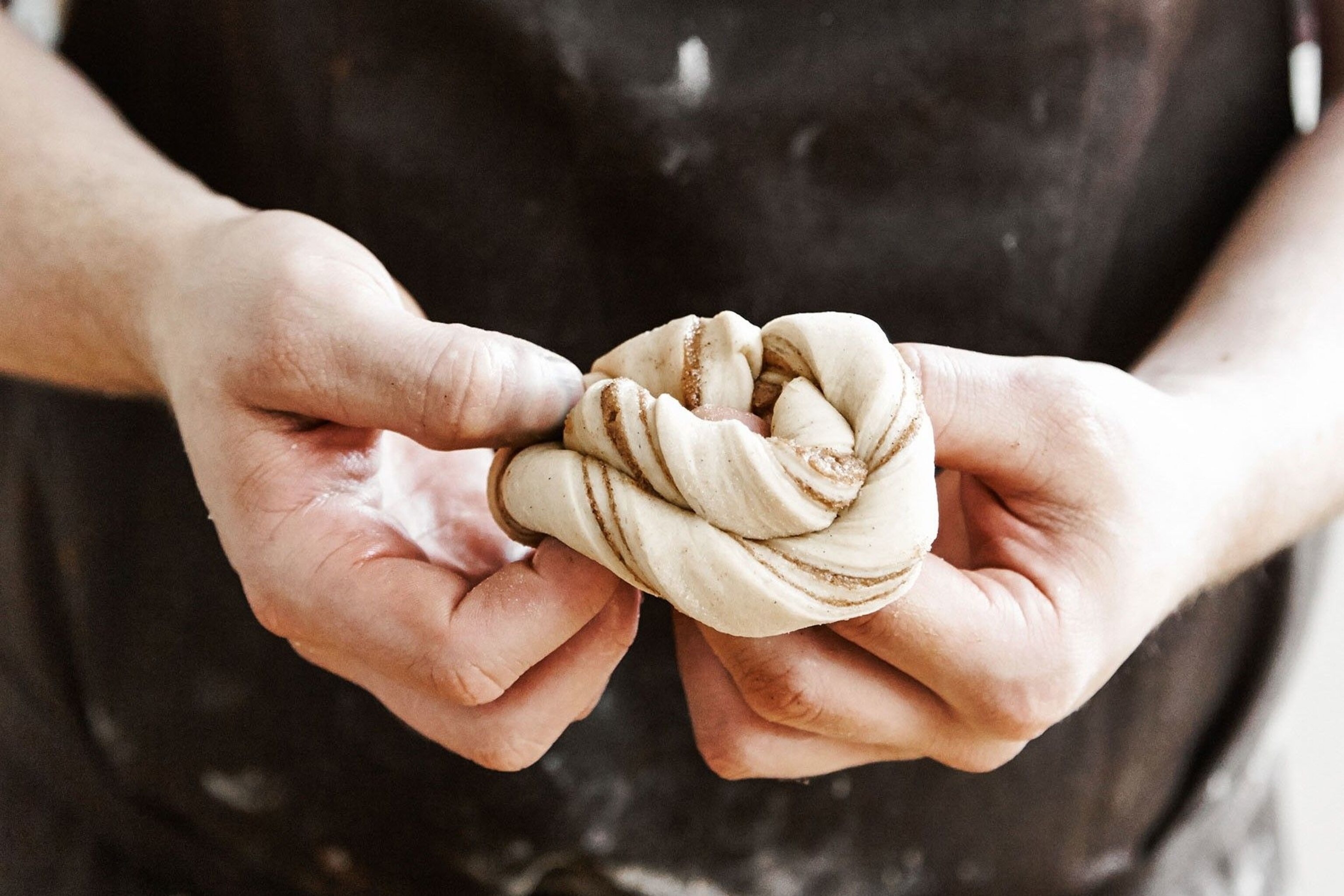 Do the twist: it might take a little practise to wrap the dough of your first cinnamon swirl.