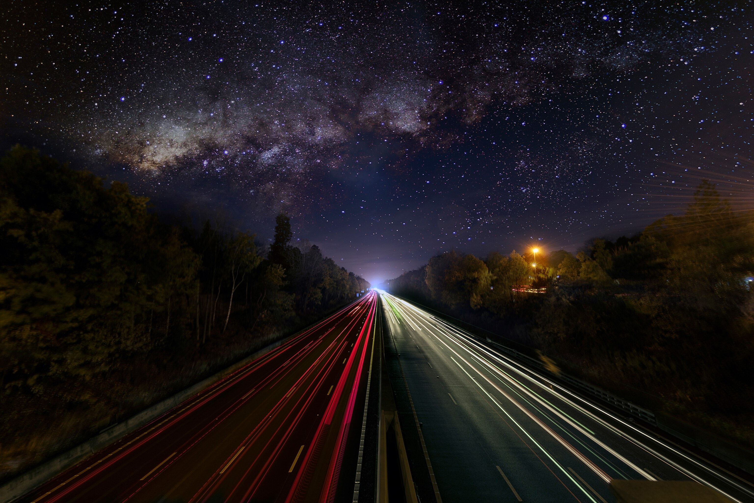 starry sky over a road.