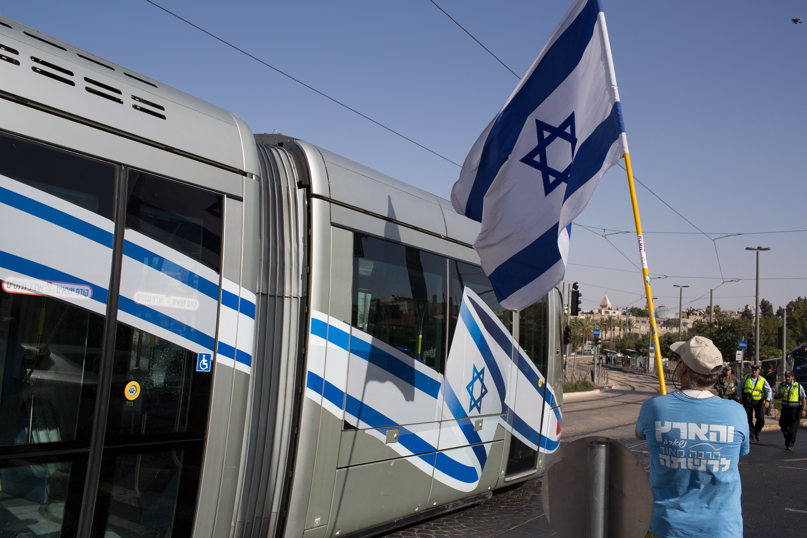 a man holding the Israeli flag in Jerusalem, Israel