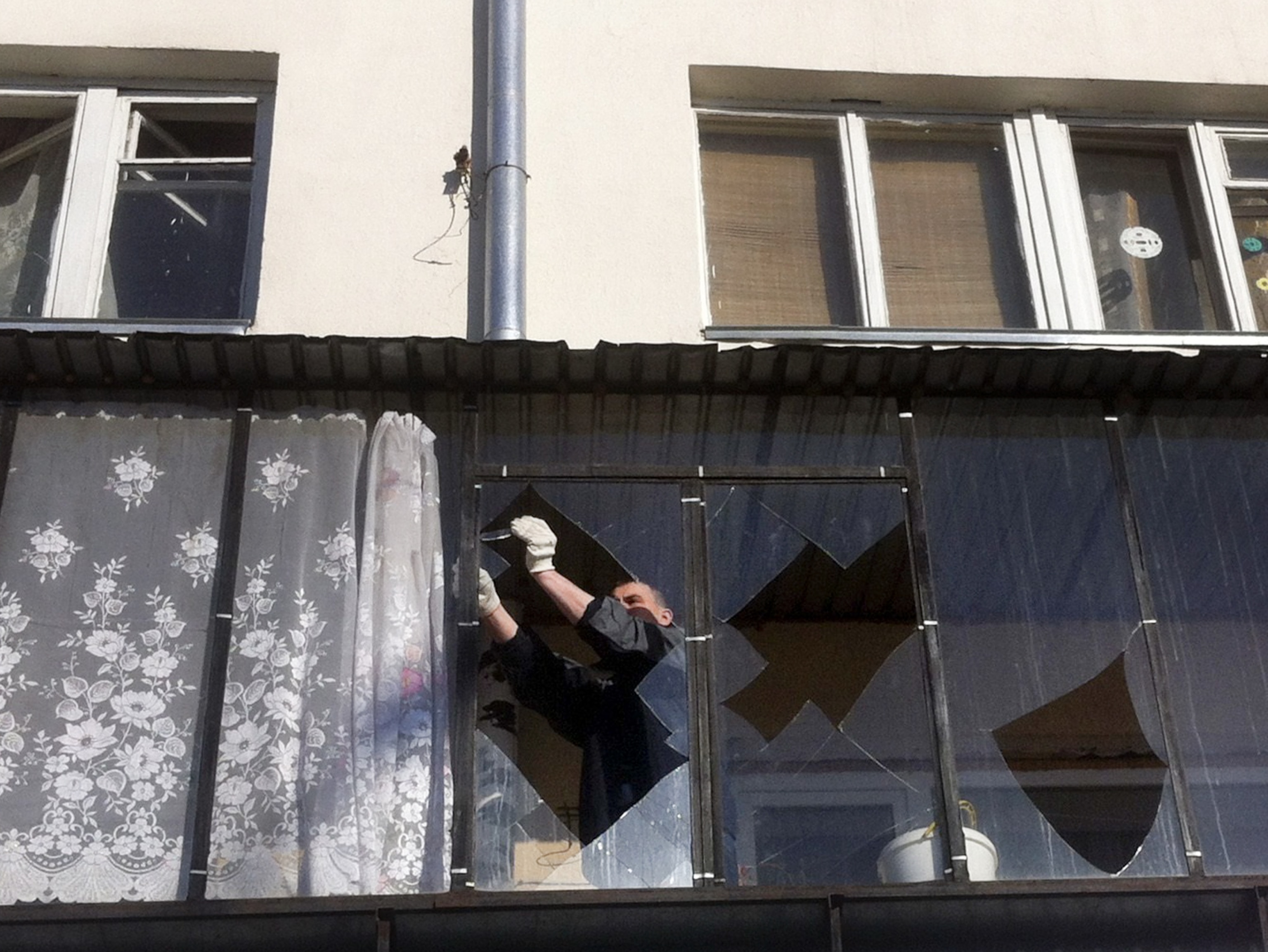 A man begins to clean up the mess left behind the meteor impact