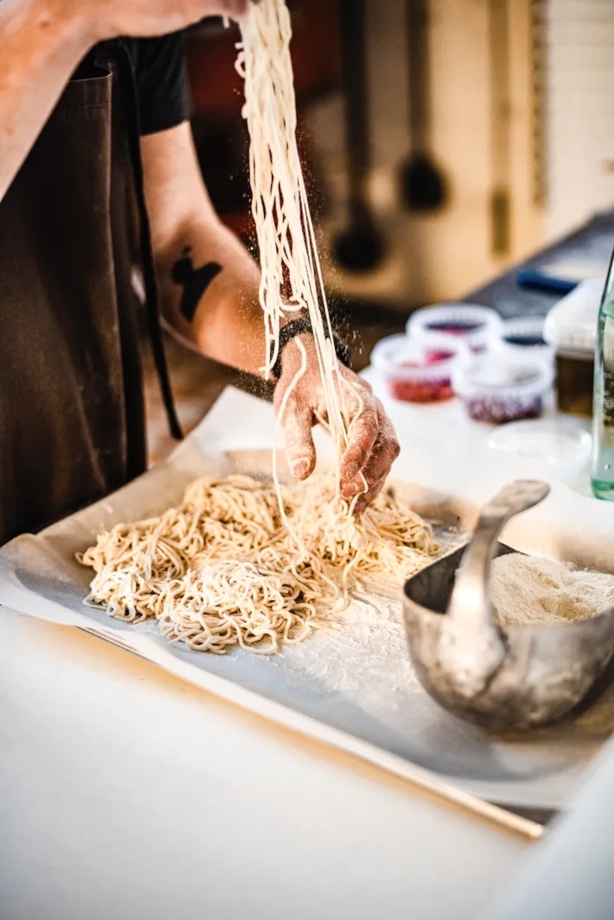 Kenneth prepares pasta at bakery Karjase Sai.