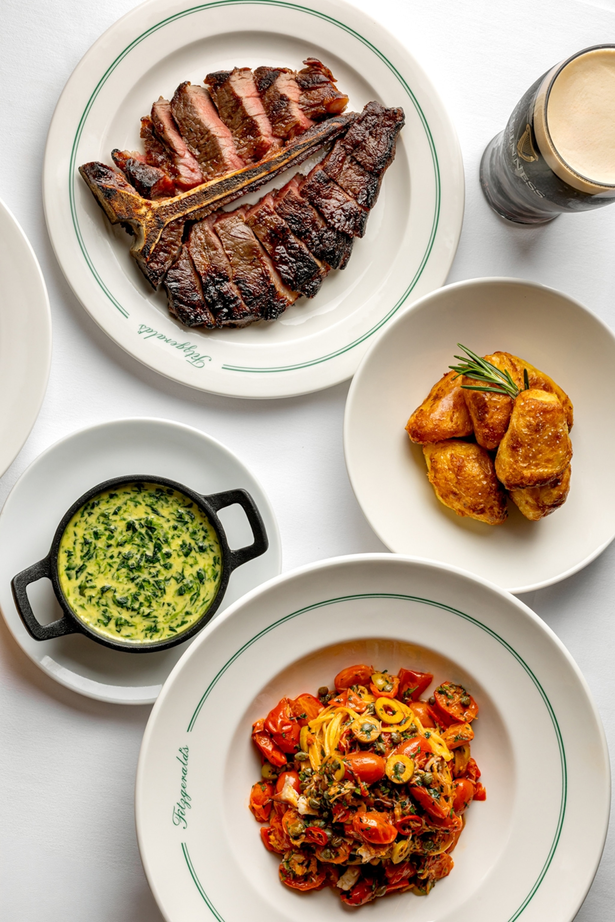 A selection of classic pub dishes like steak and spinach shot from above.