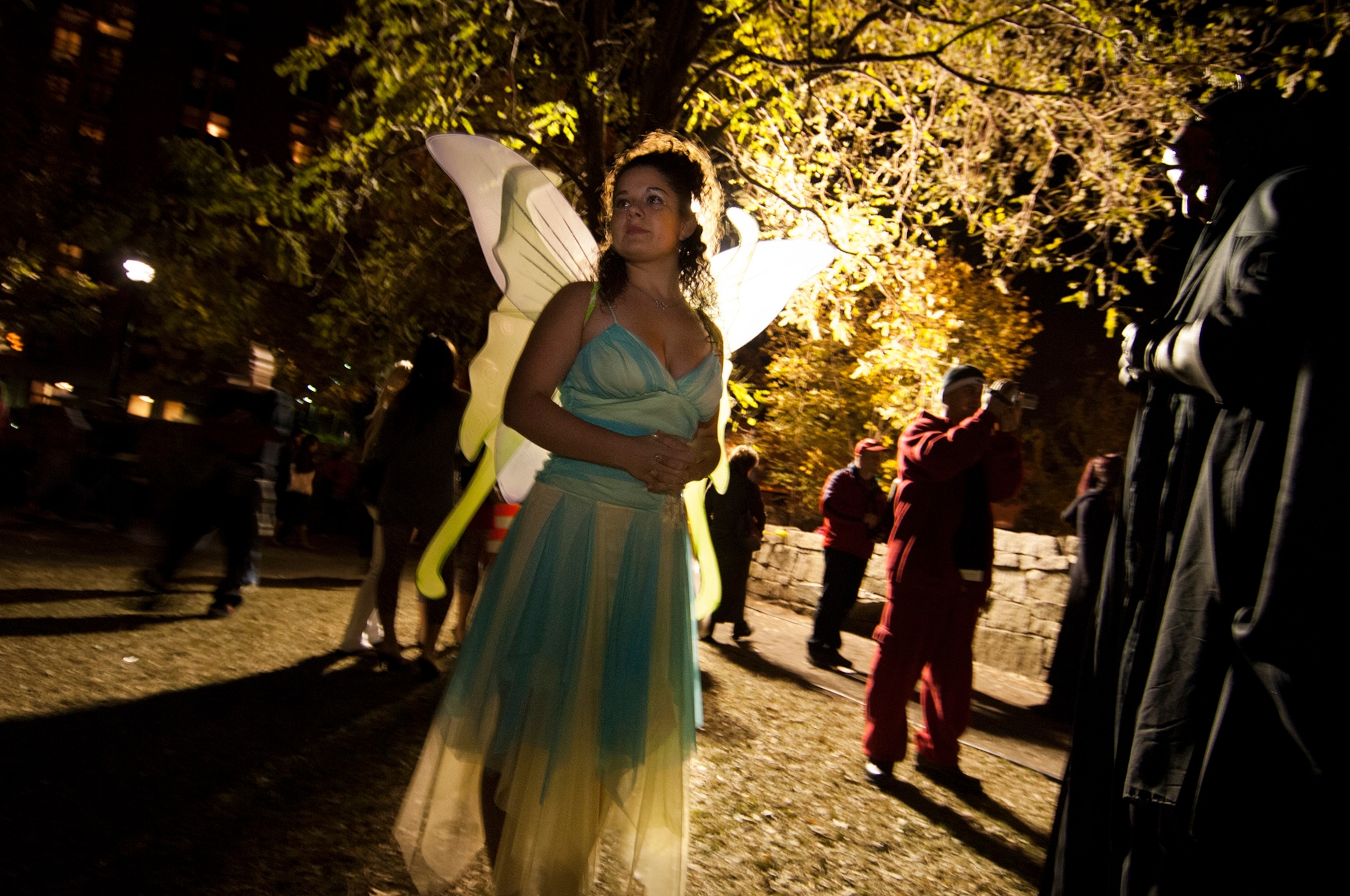 A fairy patiently waits under a tree on Halloween night in Salem, Massachusetts.
