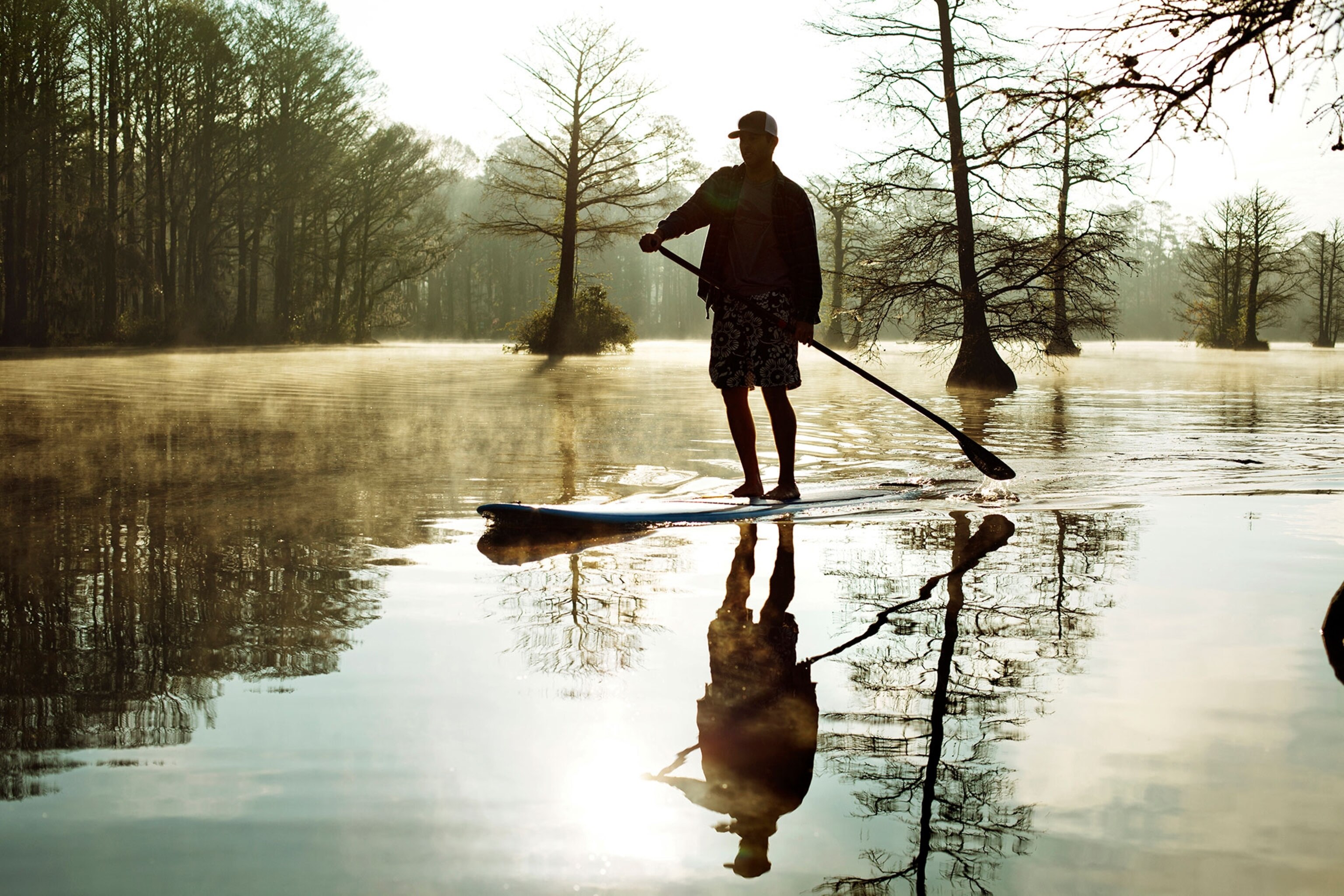 a stand up paddle boarder on Greenfield Lake, Wilmington, North Carolina