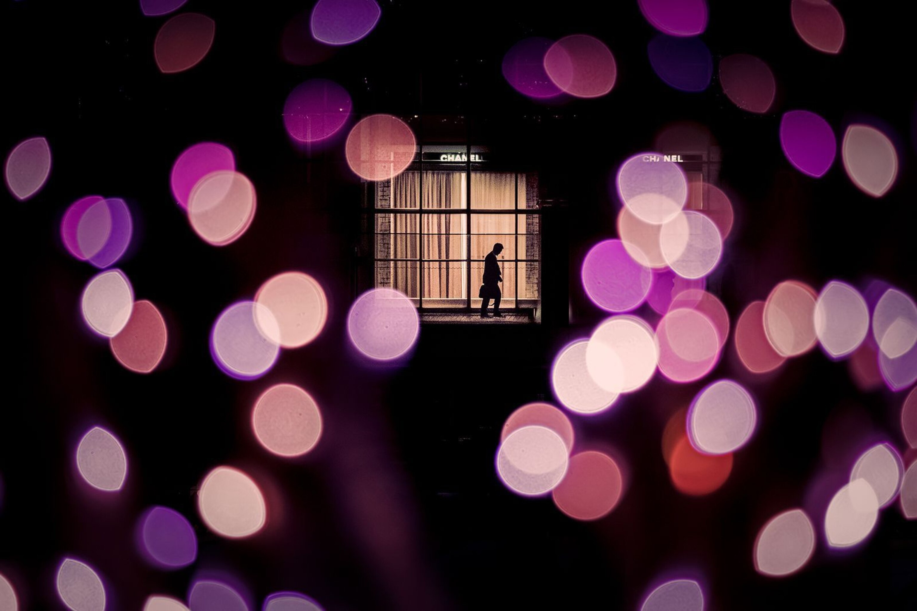 purple and pink lights surrounding Shinjuku station in Tokyo